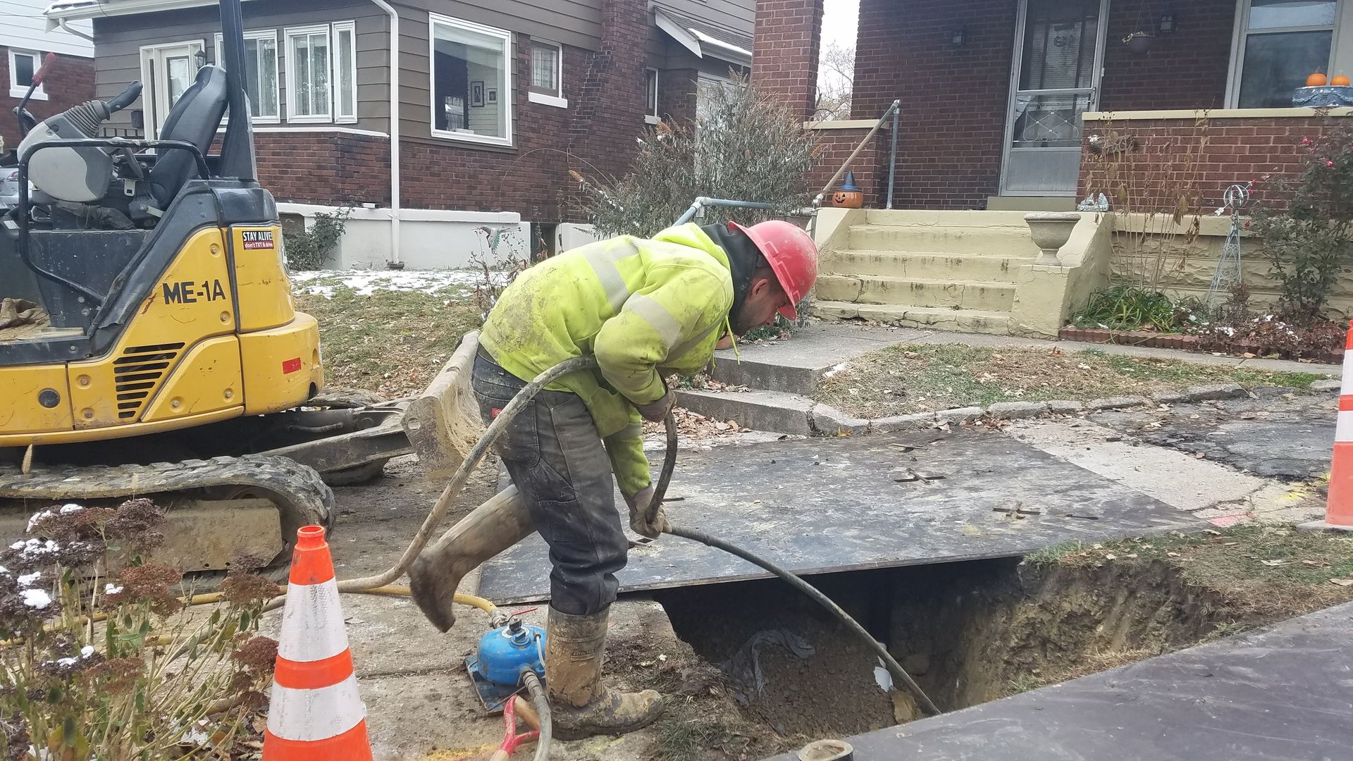 Photo of construction workers replacing lead lines in ground. 