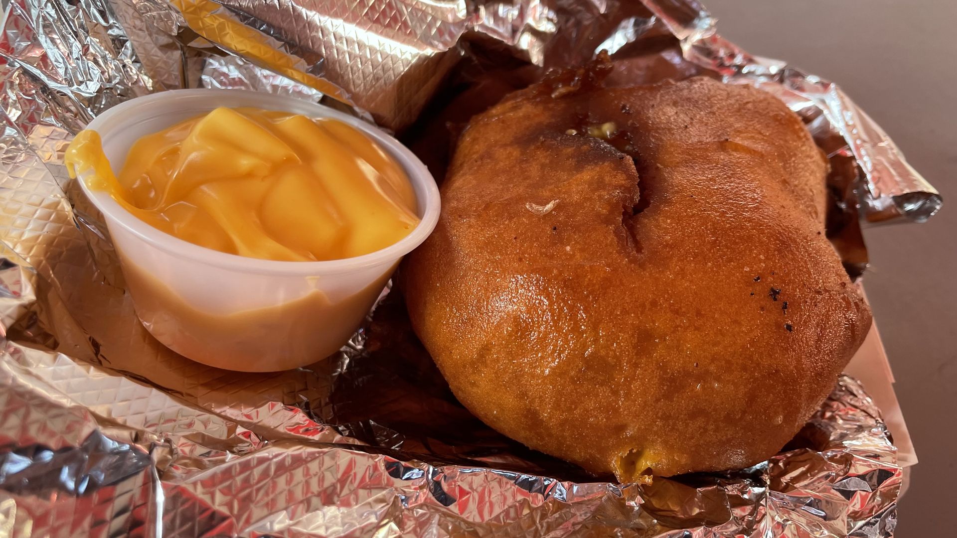 A photo of a deep fried queso burger.