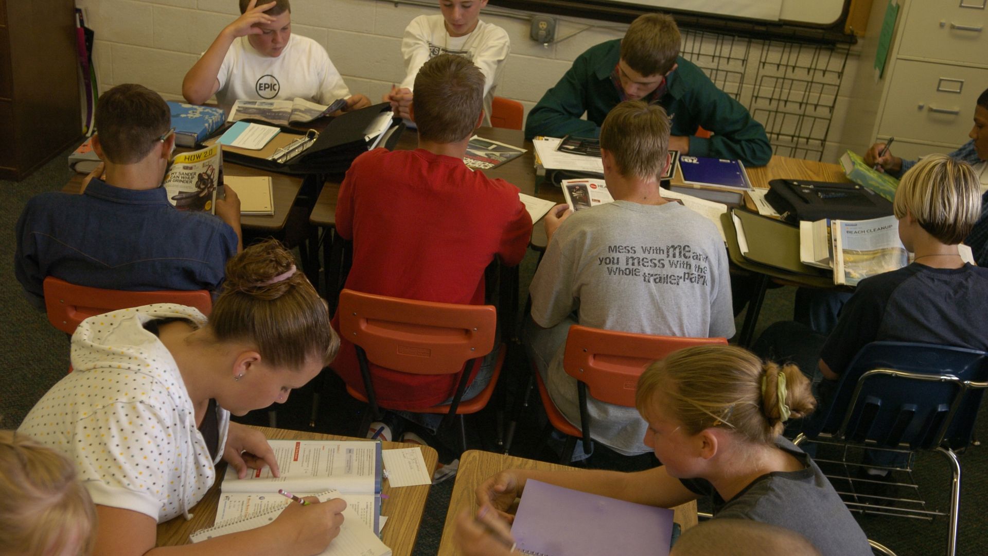 A photo of nine students working on homework at their desks.