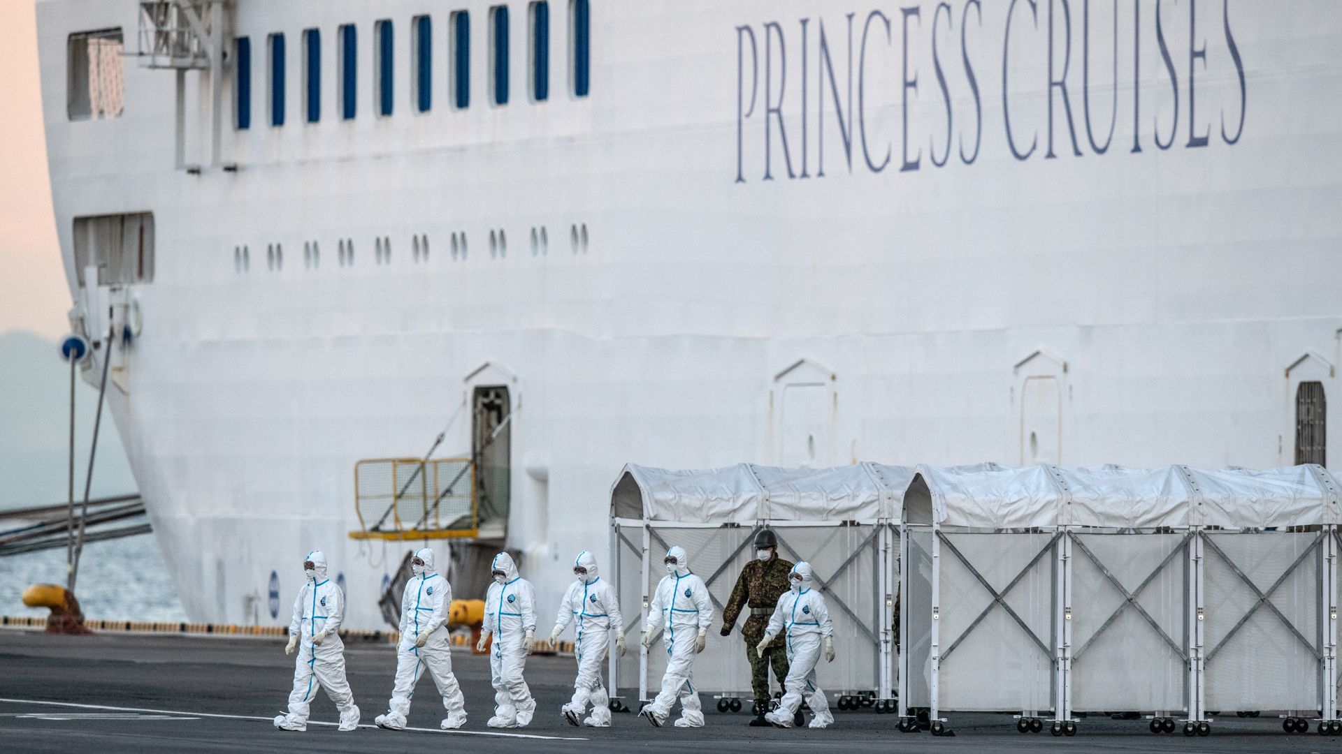  Emergency workers in protective clothing exit the Diamond Princess cruise ship in Yokohama, Japan. 