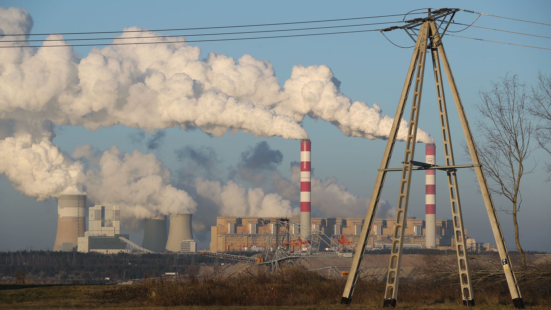 An electricity mast stands as steam and smoke rise from the Belchatow Power Station behind on November 29, 2018 at Rogowiec, Poland.