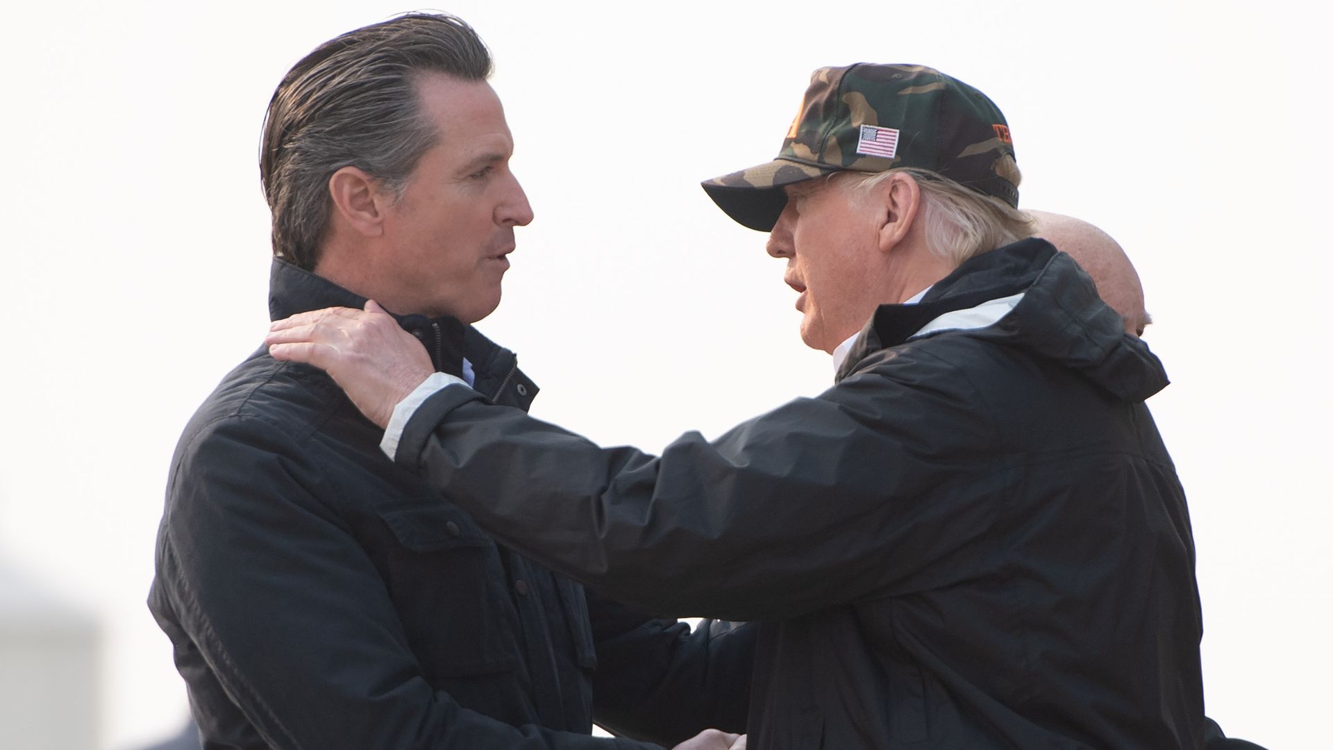 US President Donald Trump greets California Governor-elect Gavin Newsom (L) as he disembarks from Air Force One upon arrival at Beale Air Force Base in California, November 17, 2018, as he travels to view wildfire damage. - President Donald Trump arrived in California to meet with officials, victims