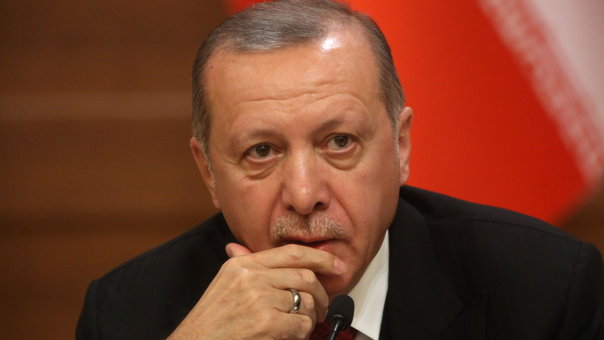 Turkish President Recep Tayyip Erdogan listens during a press conference.