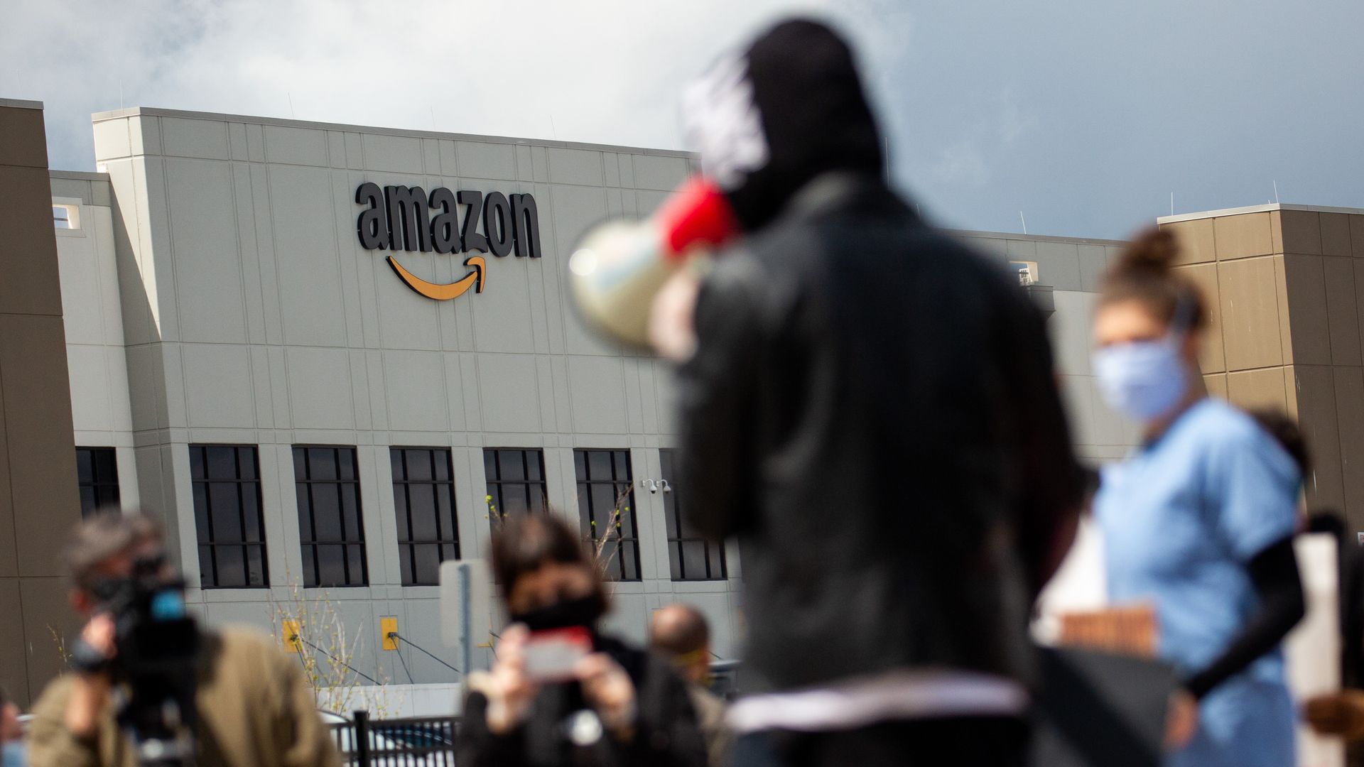 Chris Smalls, a fired Amazon fulfillment center employee, center, speaks during a protest outside an Amazon.com facility in the Staten Island borough of New York, U.S., on Friday, May 1, 2020.