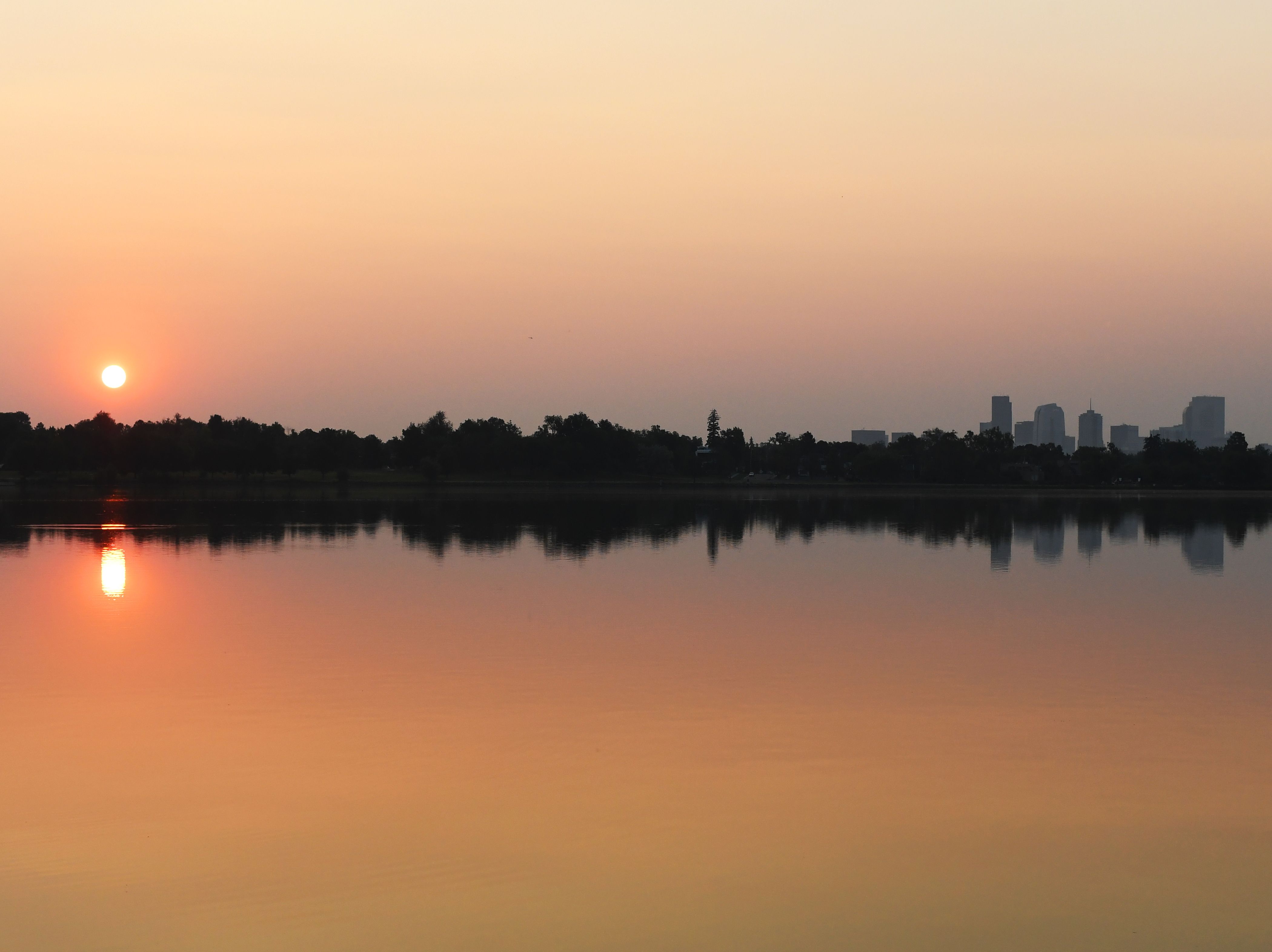  The sun rises over Sloan's Lake on poor air quality day due to smoke from California wildfires mixes with elevated ozone pollution on August 9, 2021 in Denver, Colorado. 