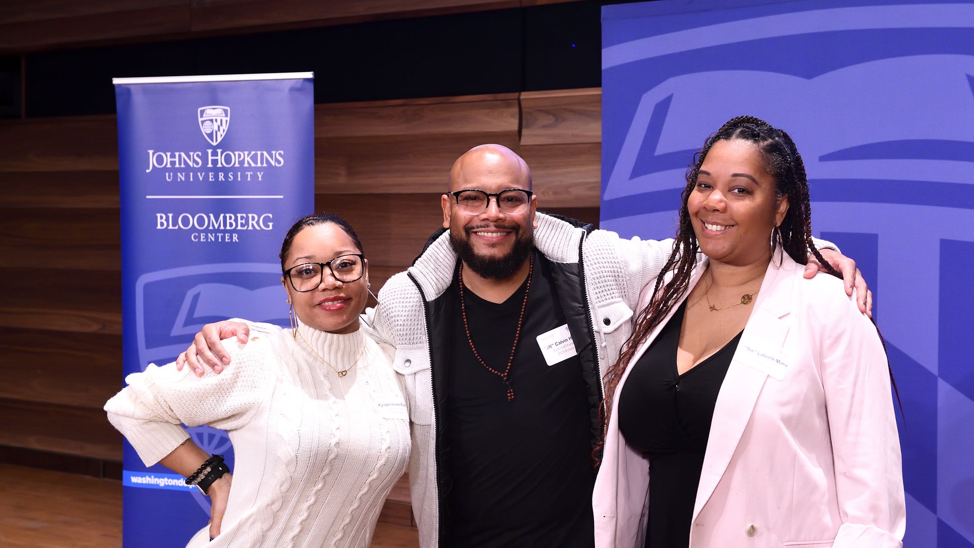 Calvin "JR" Hines (center) between two colleagues at the Johns Hopkins pitch competition