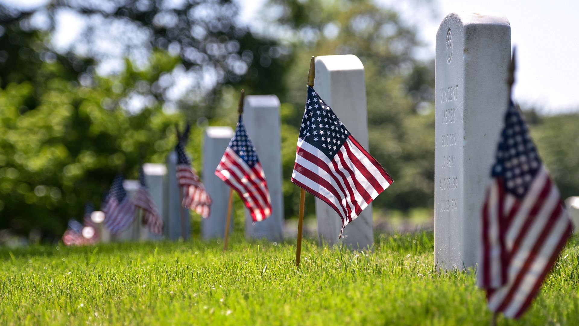Flags in front of headstones at Arlington National Cemetery.