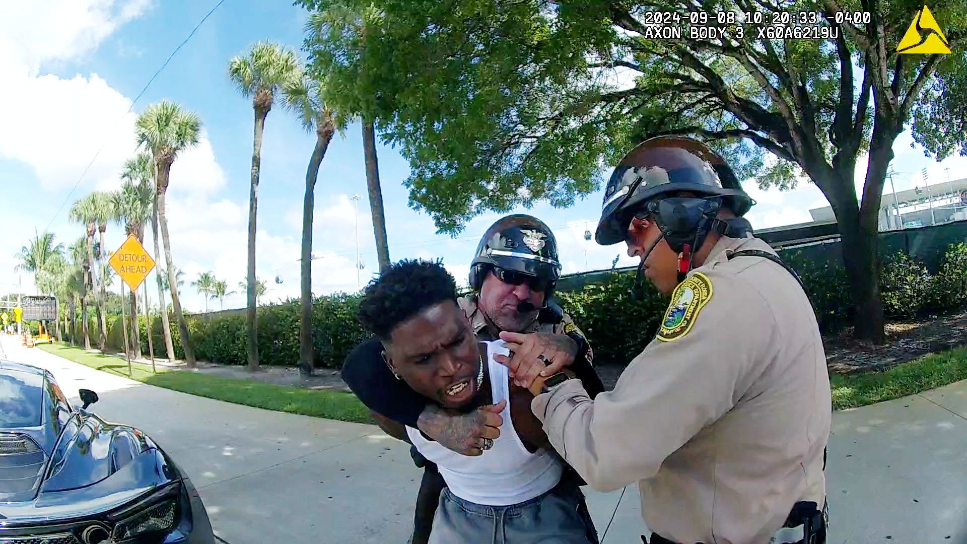 Miami Dolphins receiver Tyreek Hill is forced to the ground after being handcuffed by Miami-Dade Police Department officers in Miami, Florida, September 8, 2024 in a still image from police body camera video