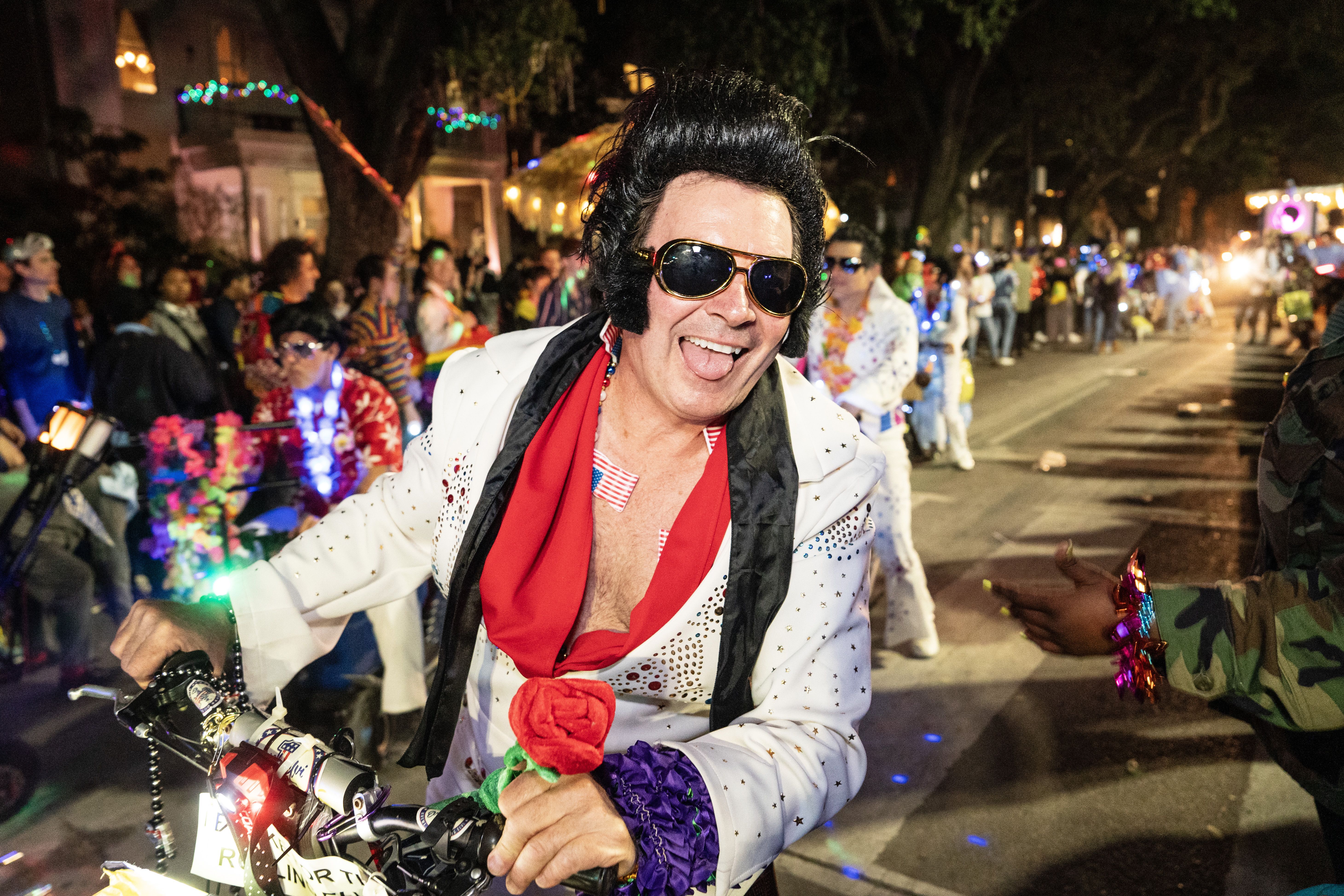 Photo shows a Rolling Elvi in the Krewe of Muses parade