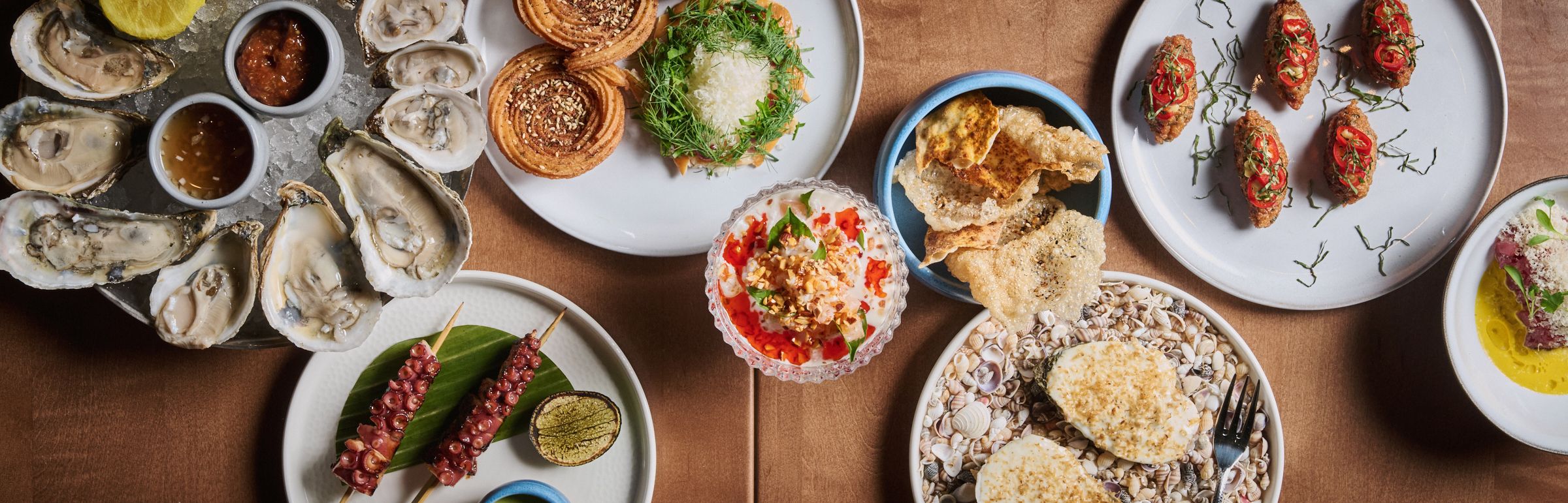 oysters, octopus and other dishes on a spread