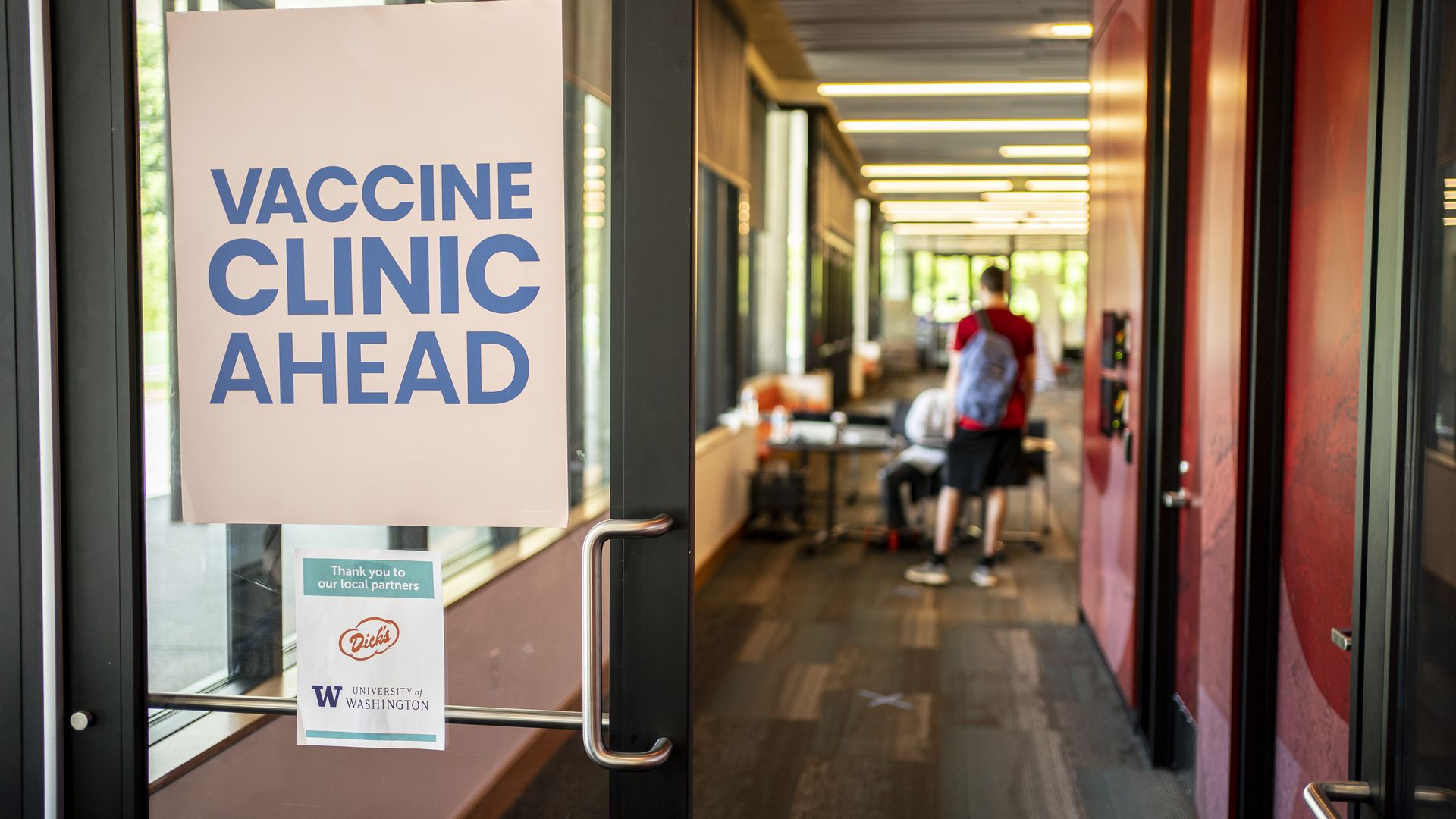 A sign directs patients at a COVID-19 vaccination clinic on the University of Washington campus on May 18