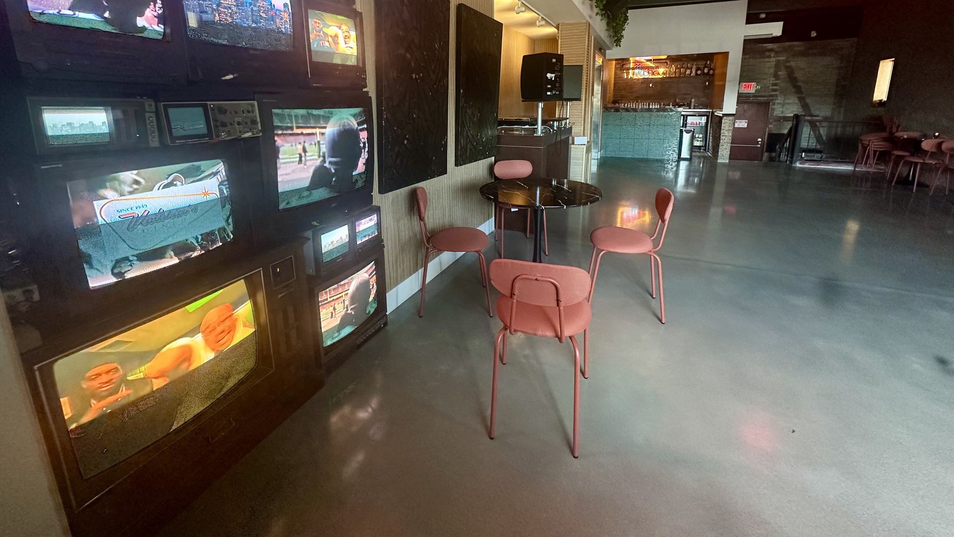 The back room of Victoria's Diner in Boston has a table for a turntable, multiple old-school TV screens, a bar and tables and chairs for jazz and music events. 