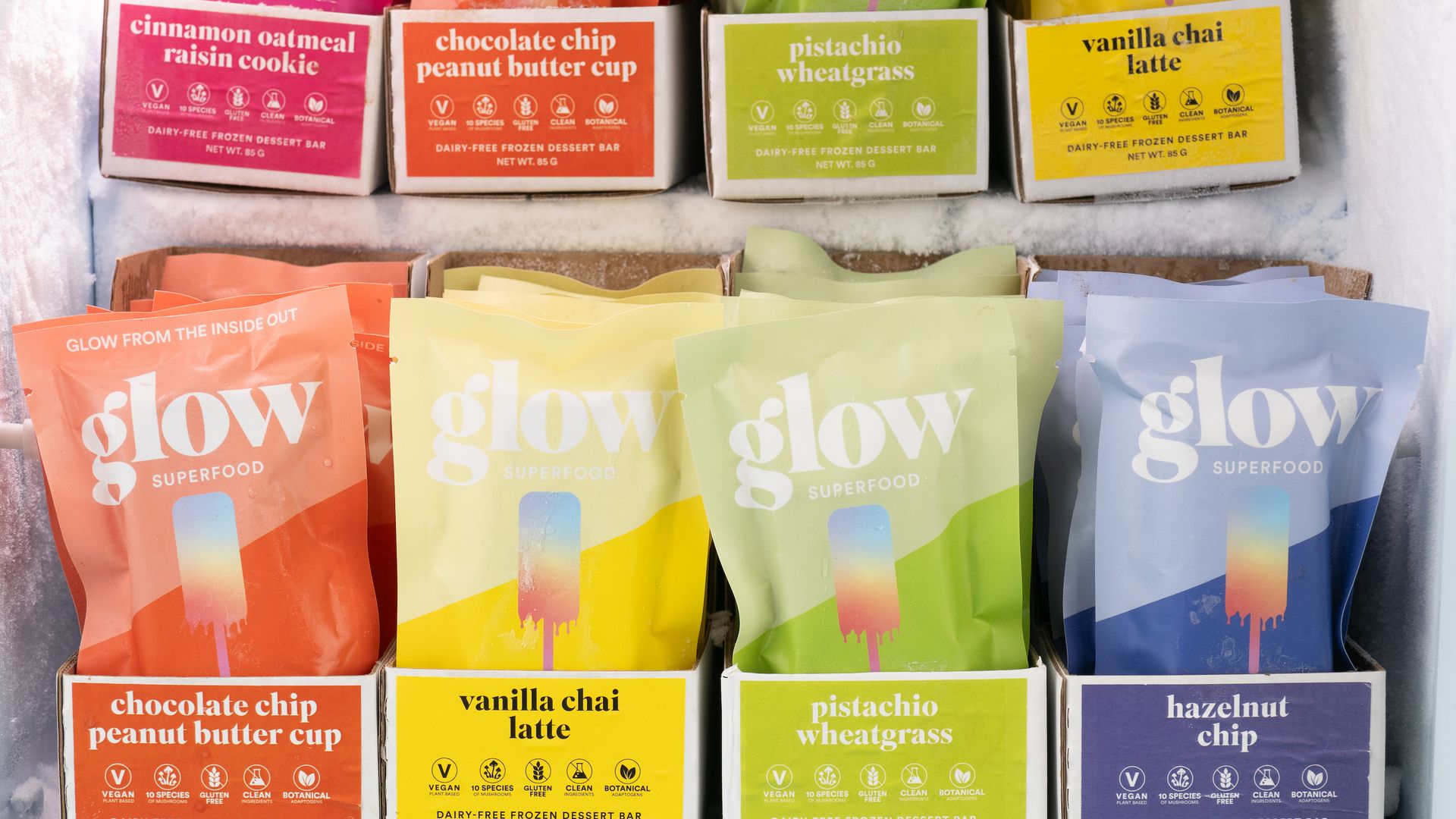 Two rows of multicolored packages of ice cream bars.