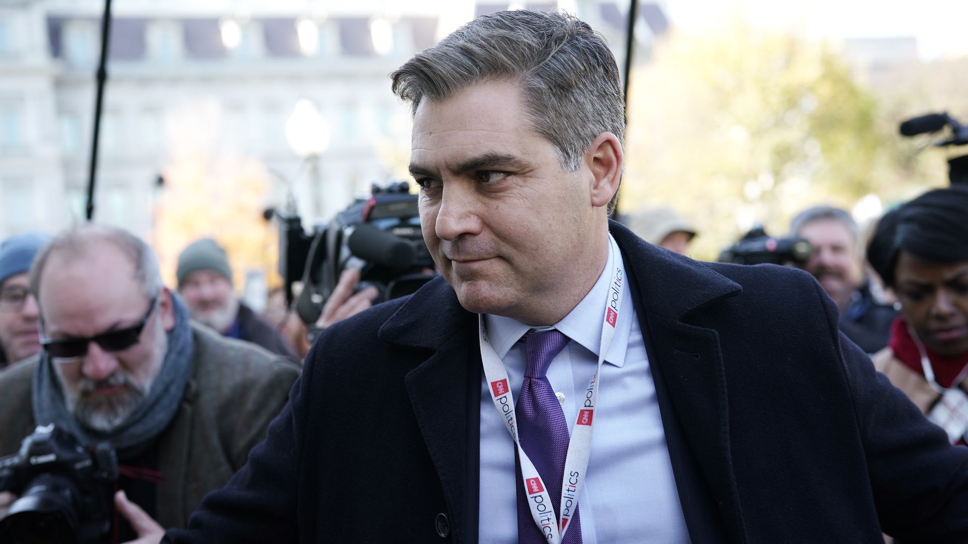 Jim Acosta walks through a crowd 