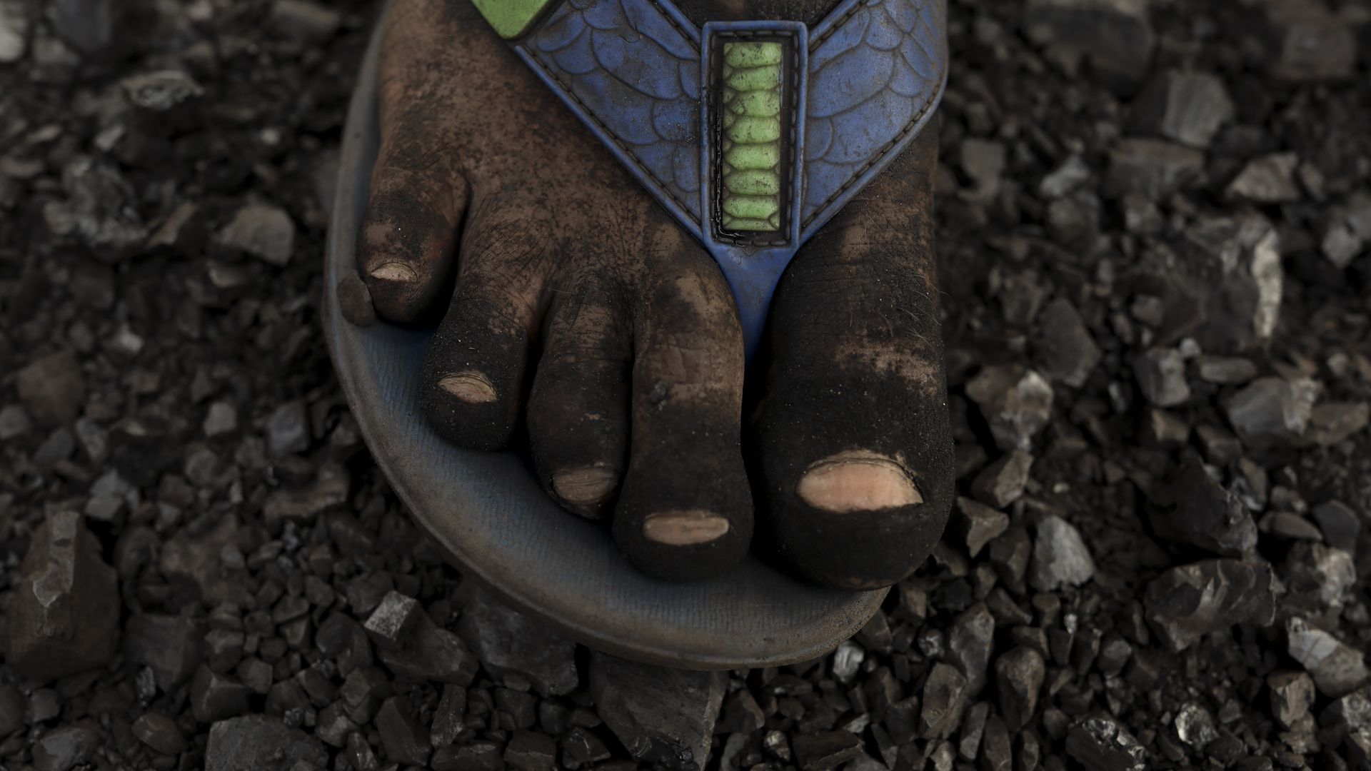 A foot view of labour how unload coal from a cargo ship in Gabtoli on the outskirts of Dhaka on January 9. After unloading 30 baskets of coal they earn around $1 USD.