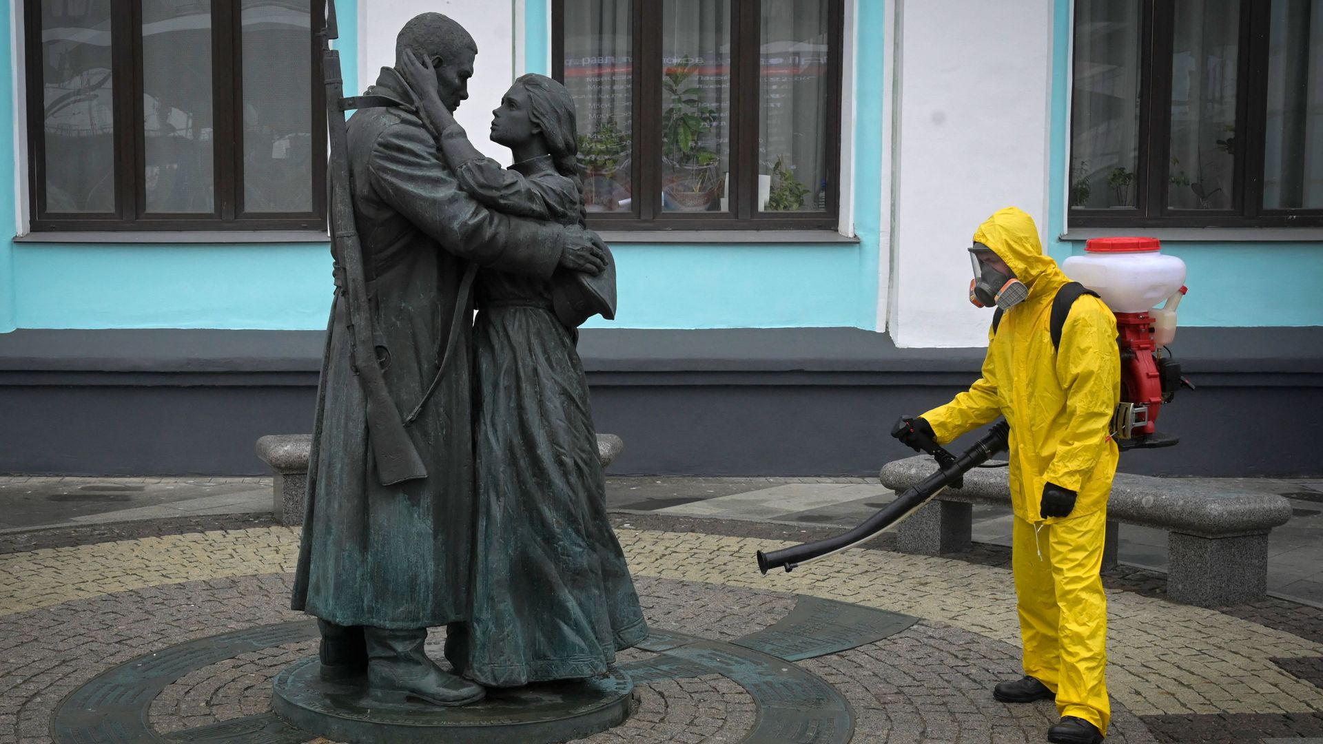 A servicemember spraying a statue in Moscow on June 11.