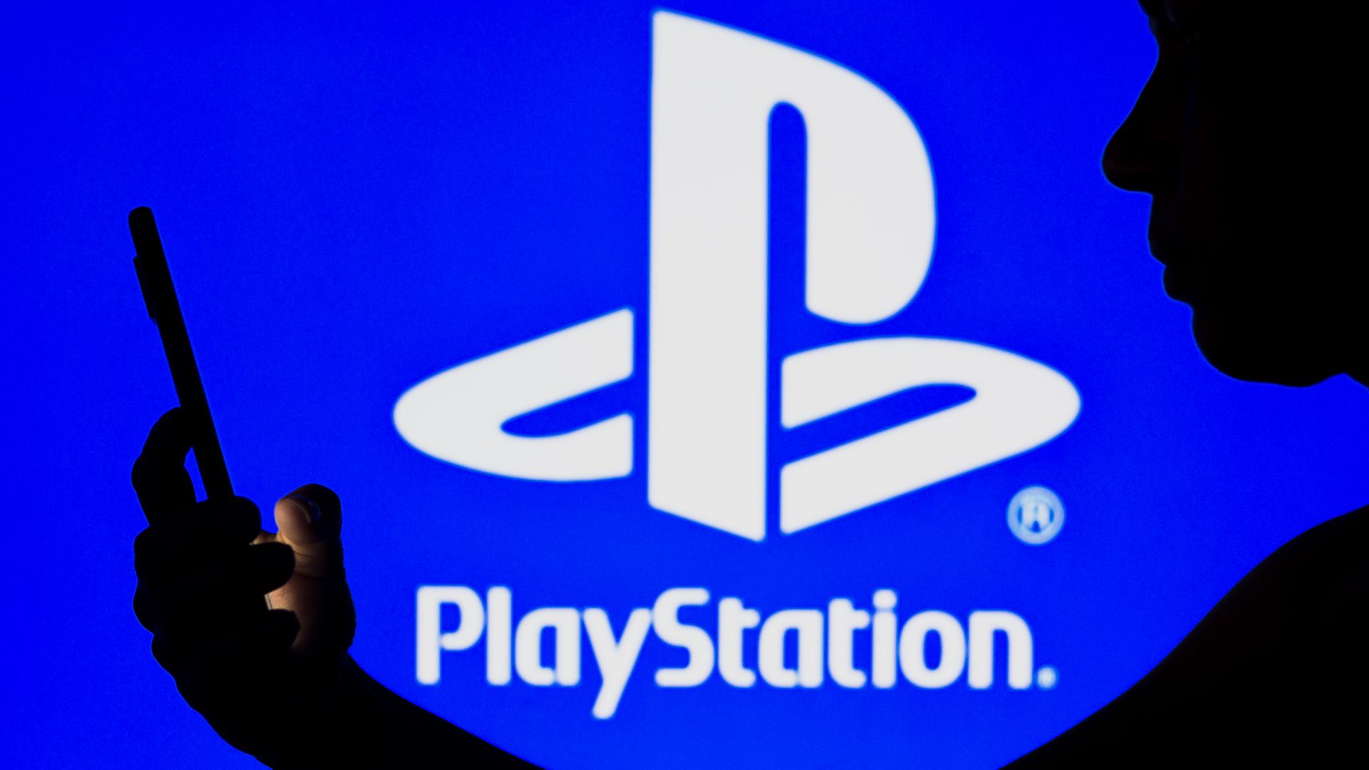 PlayStation logo and the silhouette of a woman holding a phone