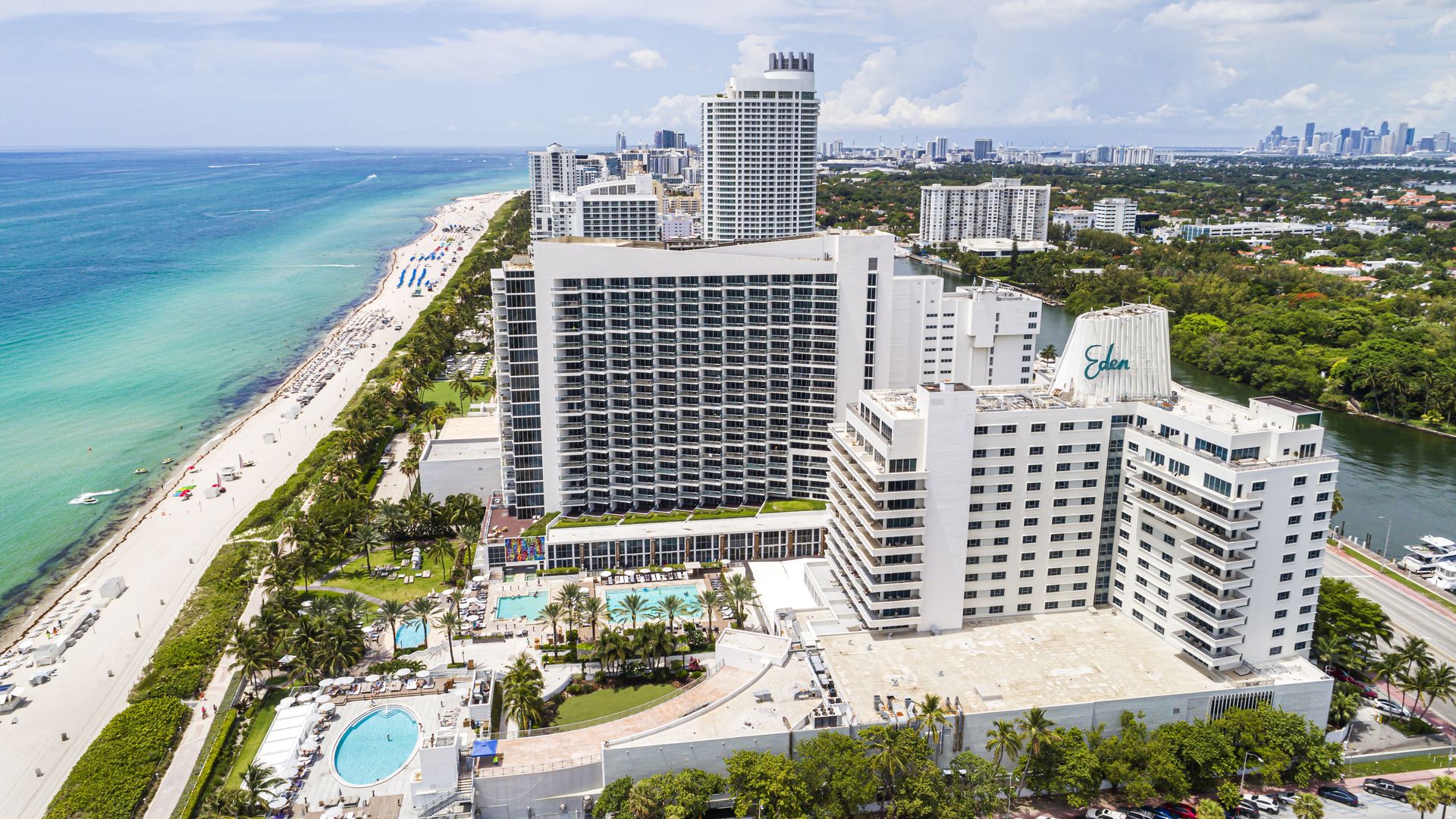 Miami Beach, Florida, aerial view, Atlantic Ocean shoreline public beach hotels condominium buildings, Eden Roc Tresor Tower and Fontainebleau hotel. 