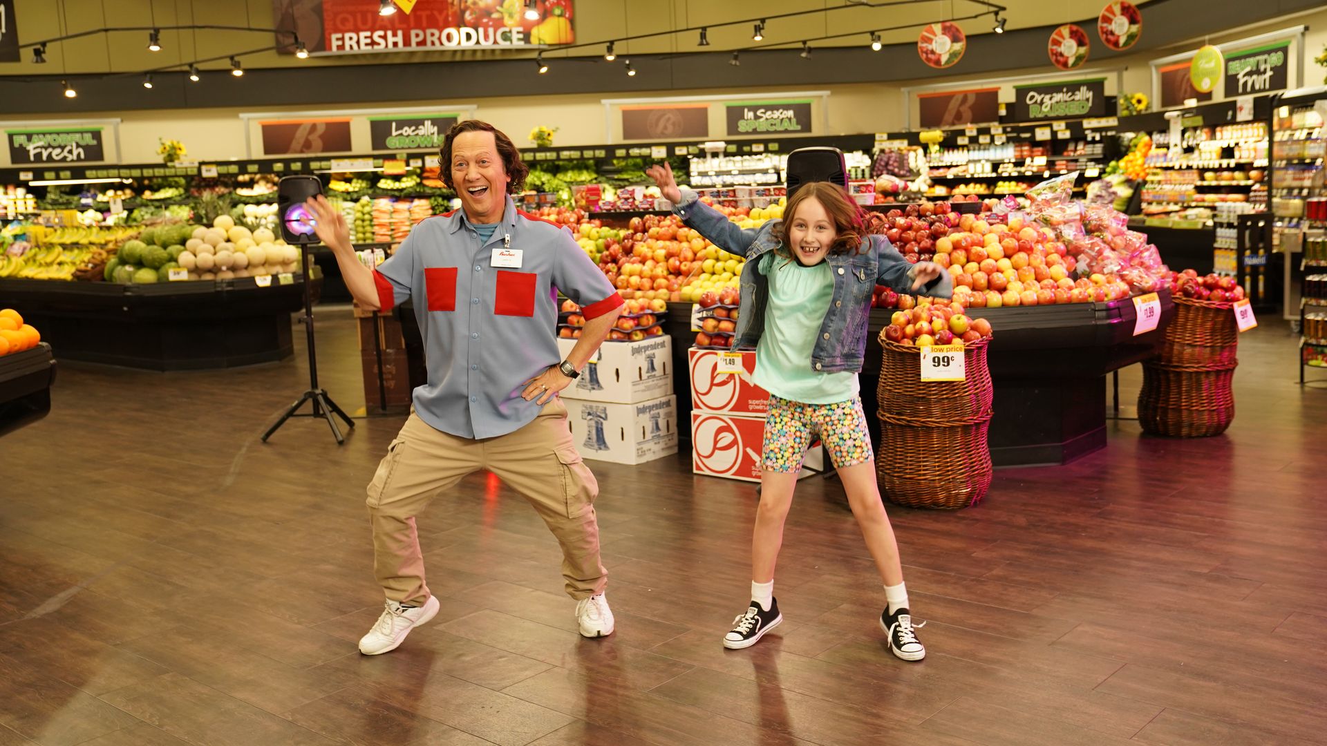 Rob Schneider and Miranda Scarlett Schneider pose in a supermarket for a scene in a movie