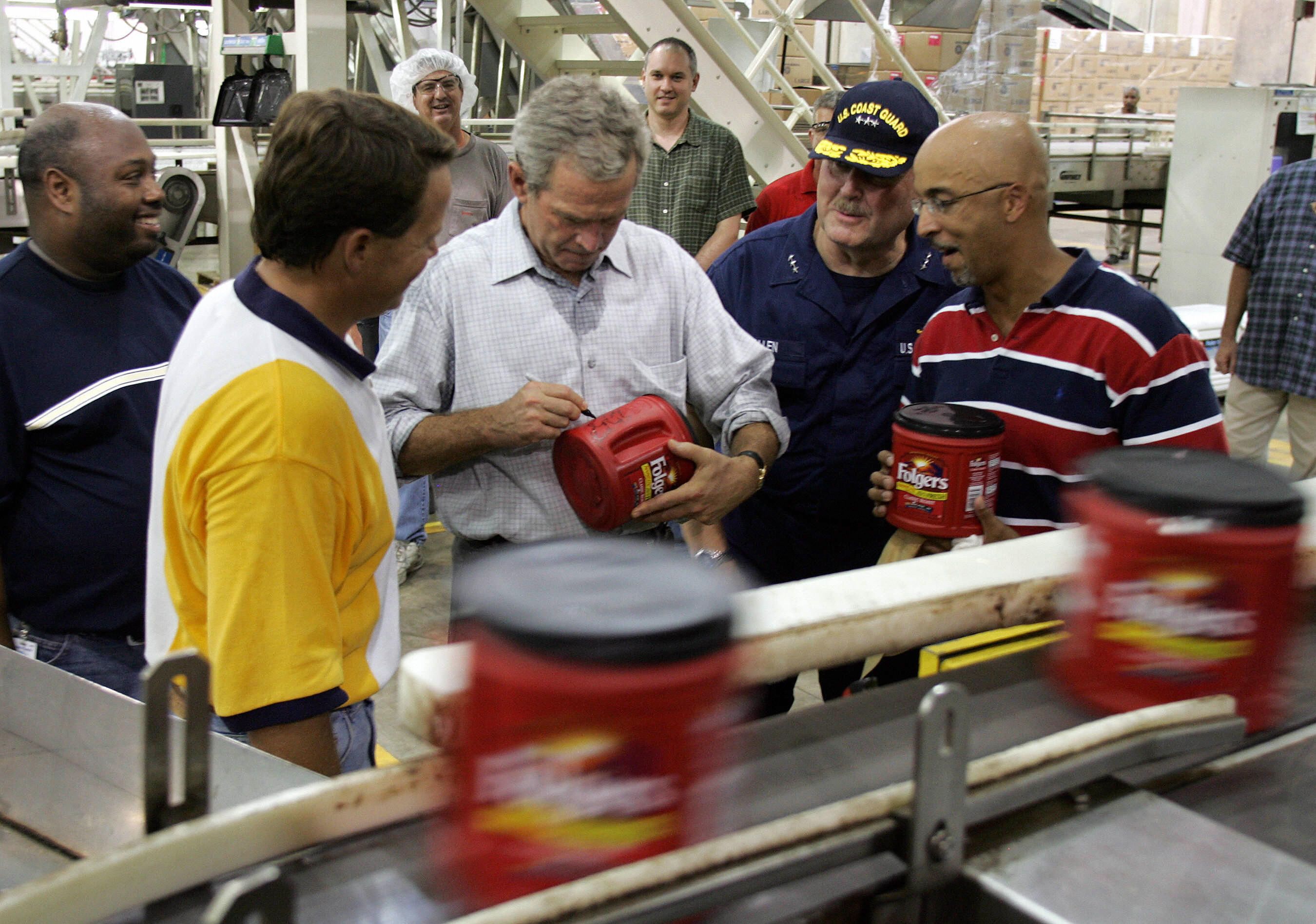 Photo shows a picture of George W. Bush signing a container of Folgers.