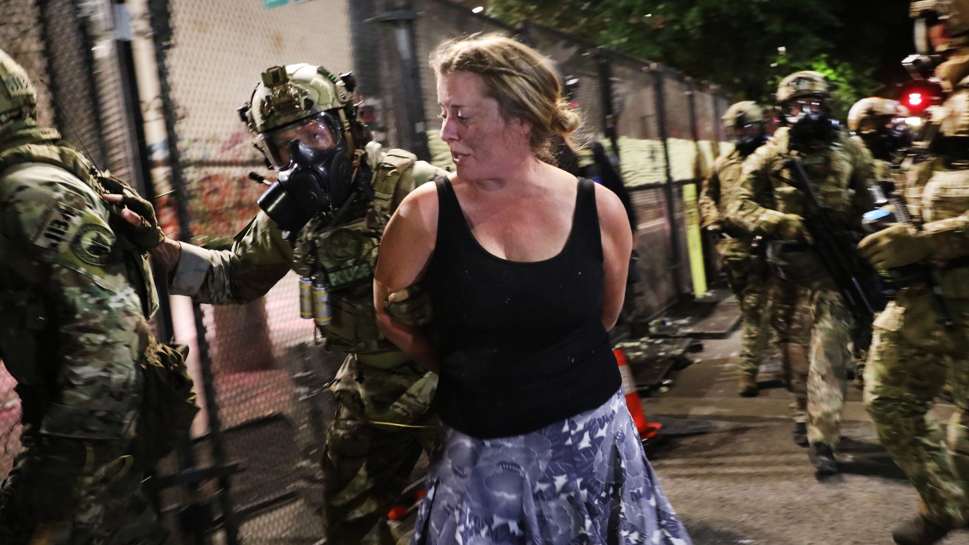 Federal police make an arrest as they confront protesters in front of the  federal courthouse in downtown Portland as the city experiences another night of unrest on July 26, 2020 in Portland, Oregon.