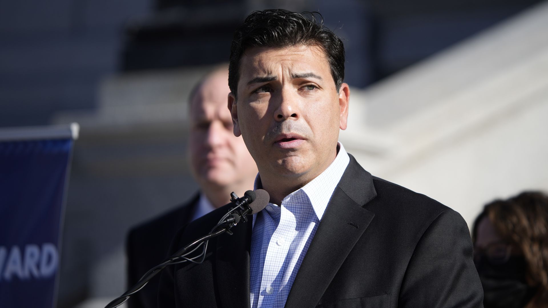 State Senate President Leroy Garcia speaks on the Capitol steps Monday with Gov. Jared Polis standing behind him. Photo: David Zalubowski/AP