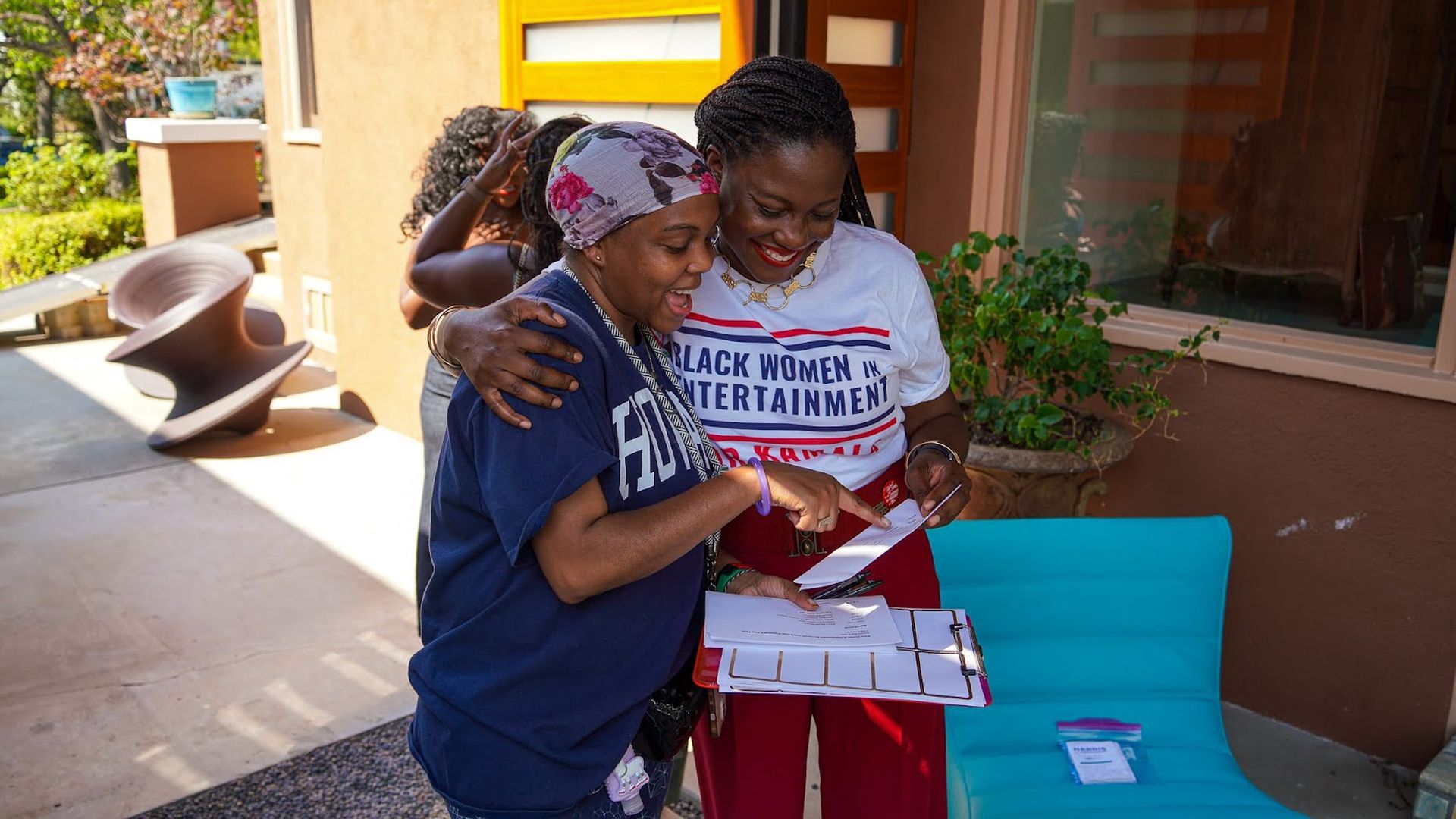 Evan Seymour who launched the BWIE4Kamala initiative talks to a member at an event. 