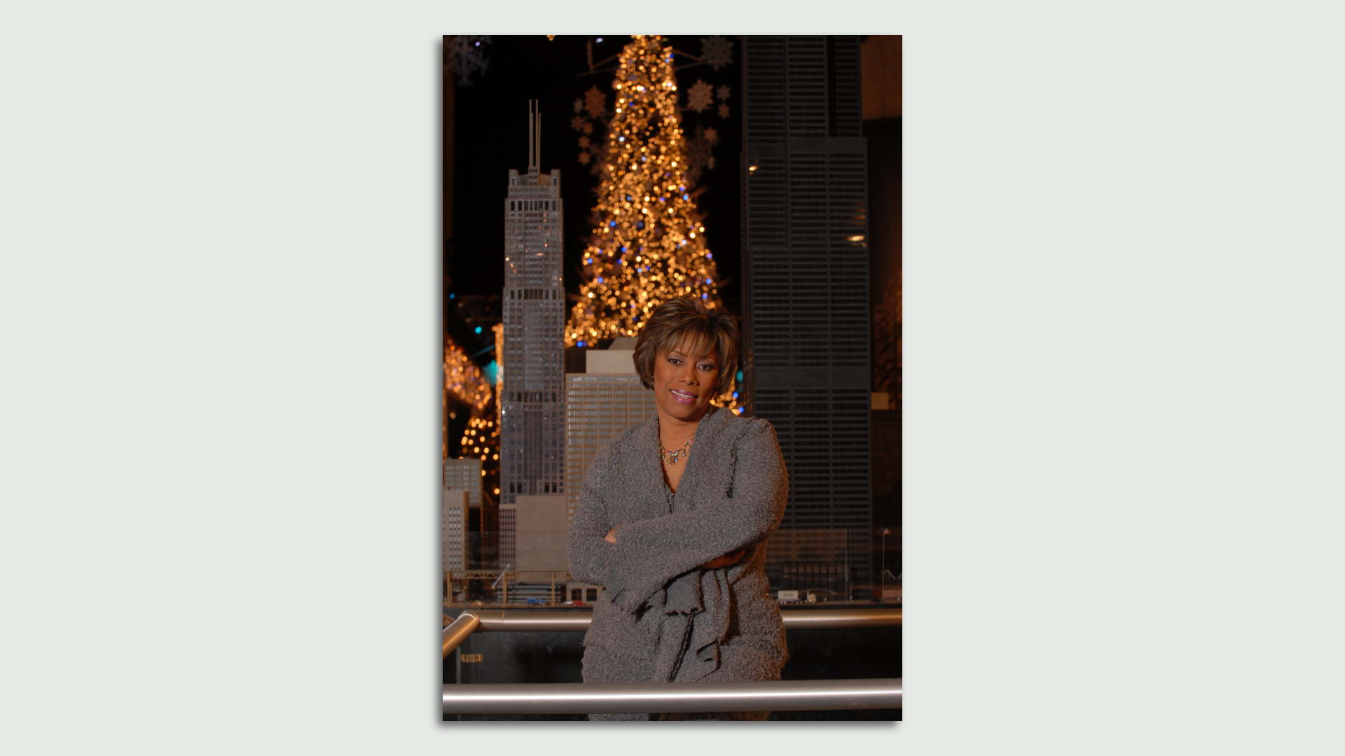 Photo of a woman standing in front of a Christmas tree