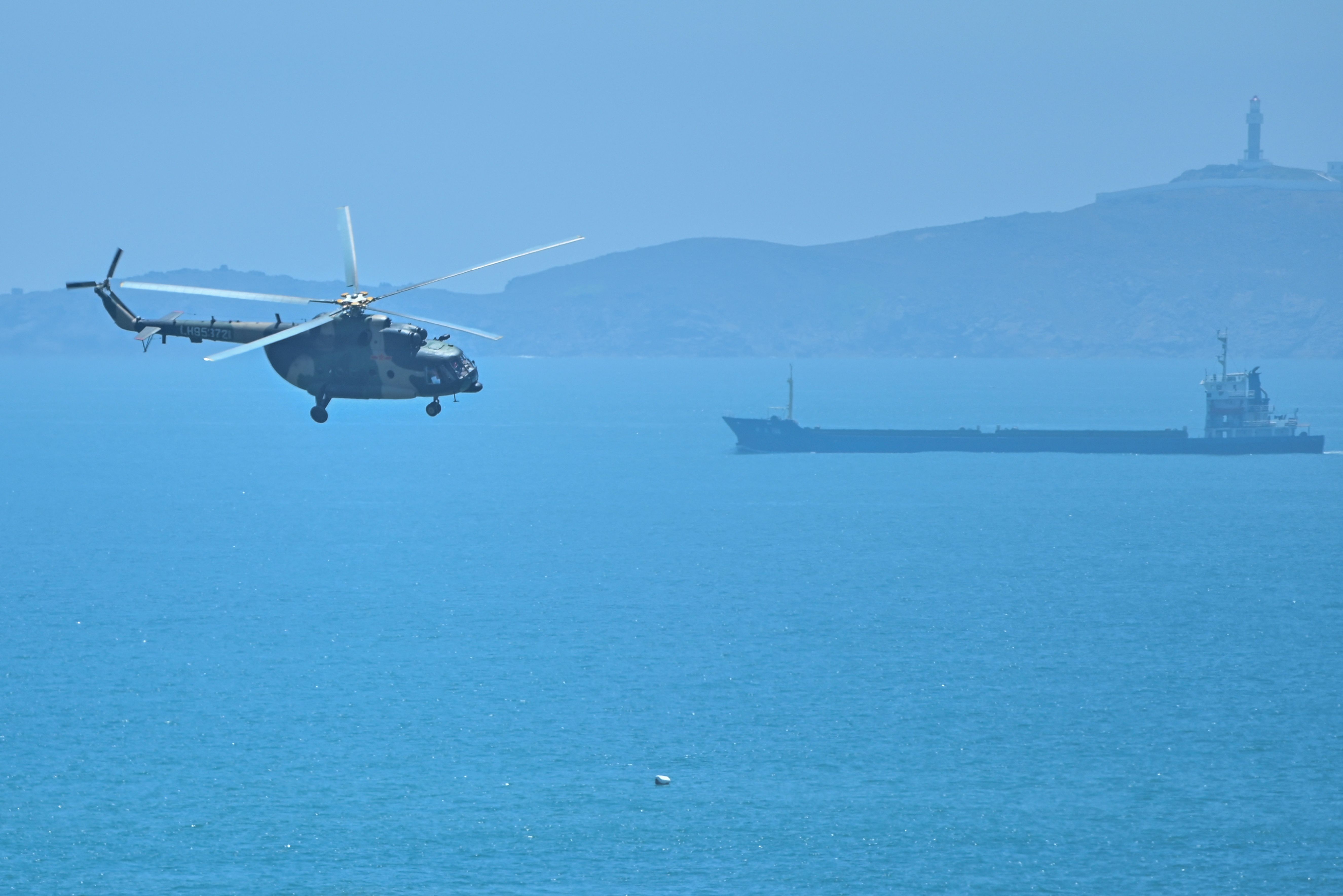 A Chinese military helicopter flies past Pingtan Island, one of China's closest points to Taiwan, on Aug. 4. 
