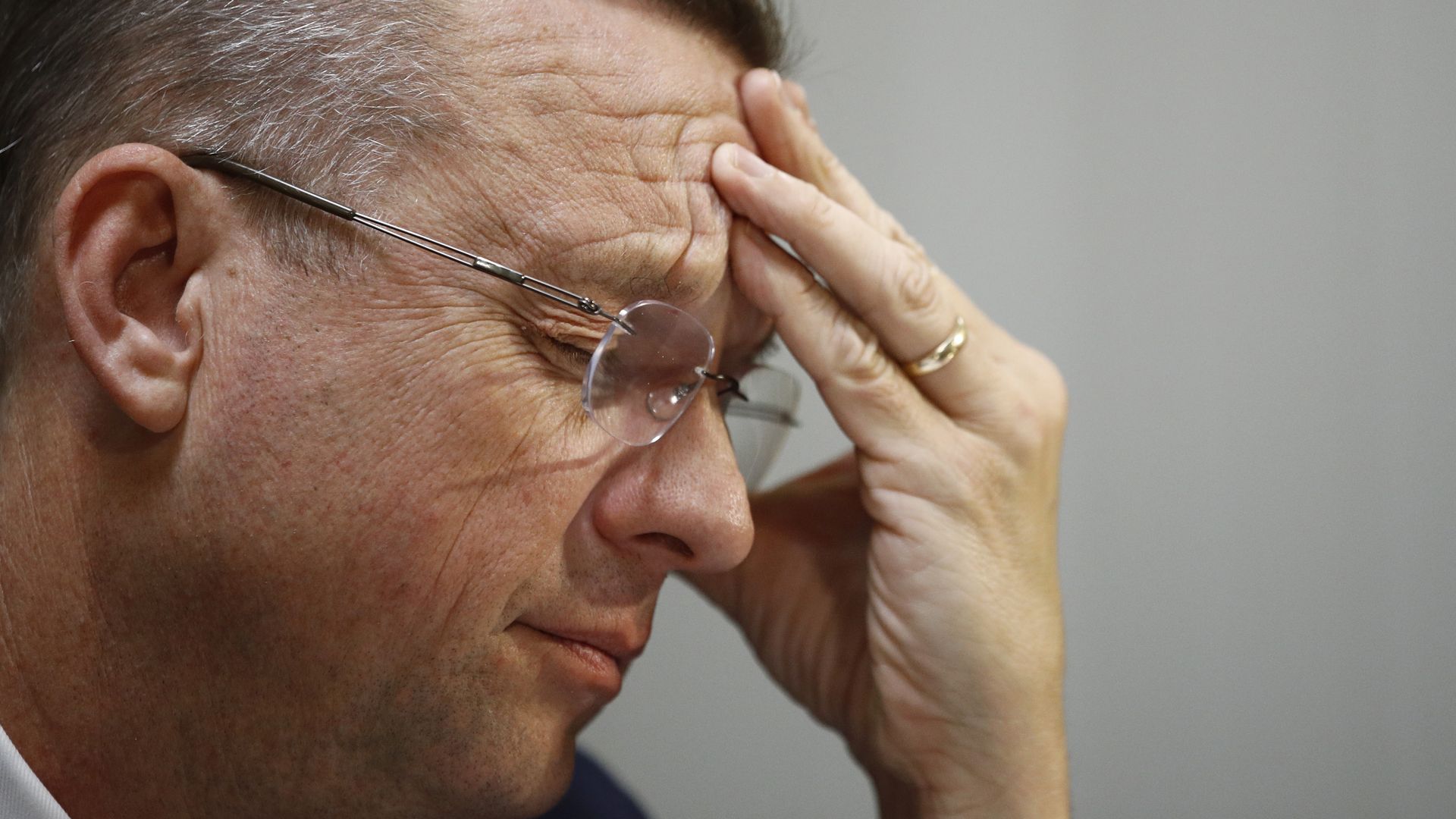 Doug Collins touching his forehead.