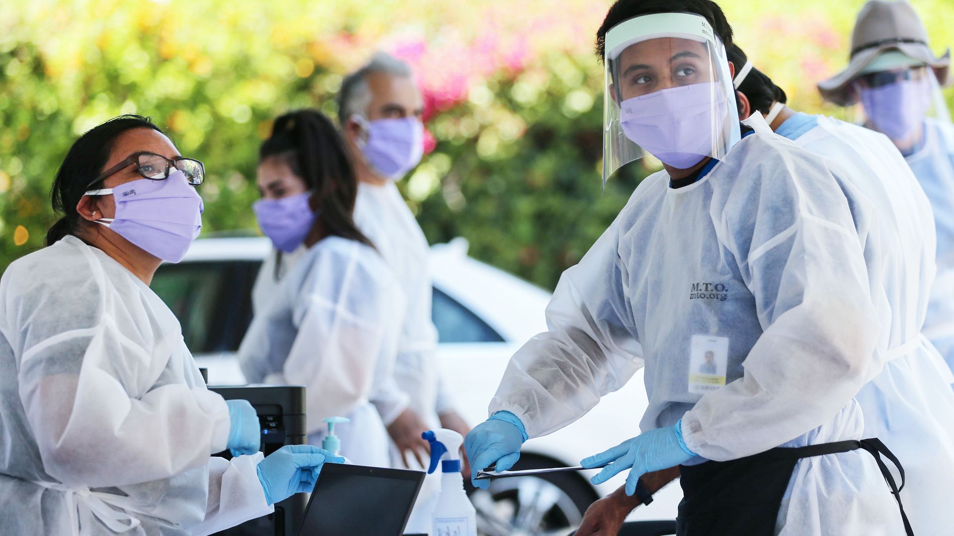 Healthcare workers handling coronavirus tests in Los Angeles on August 11.