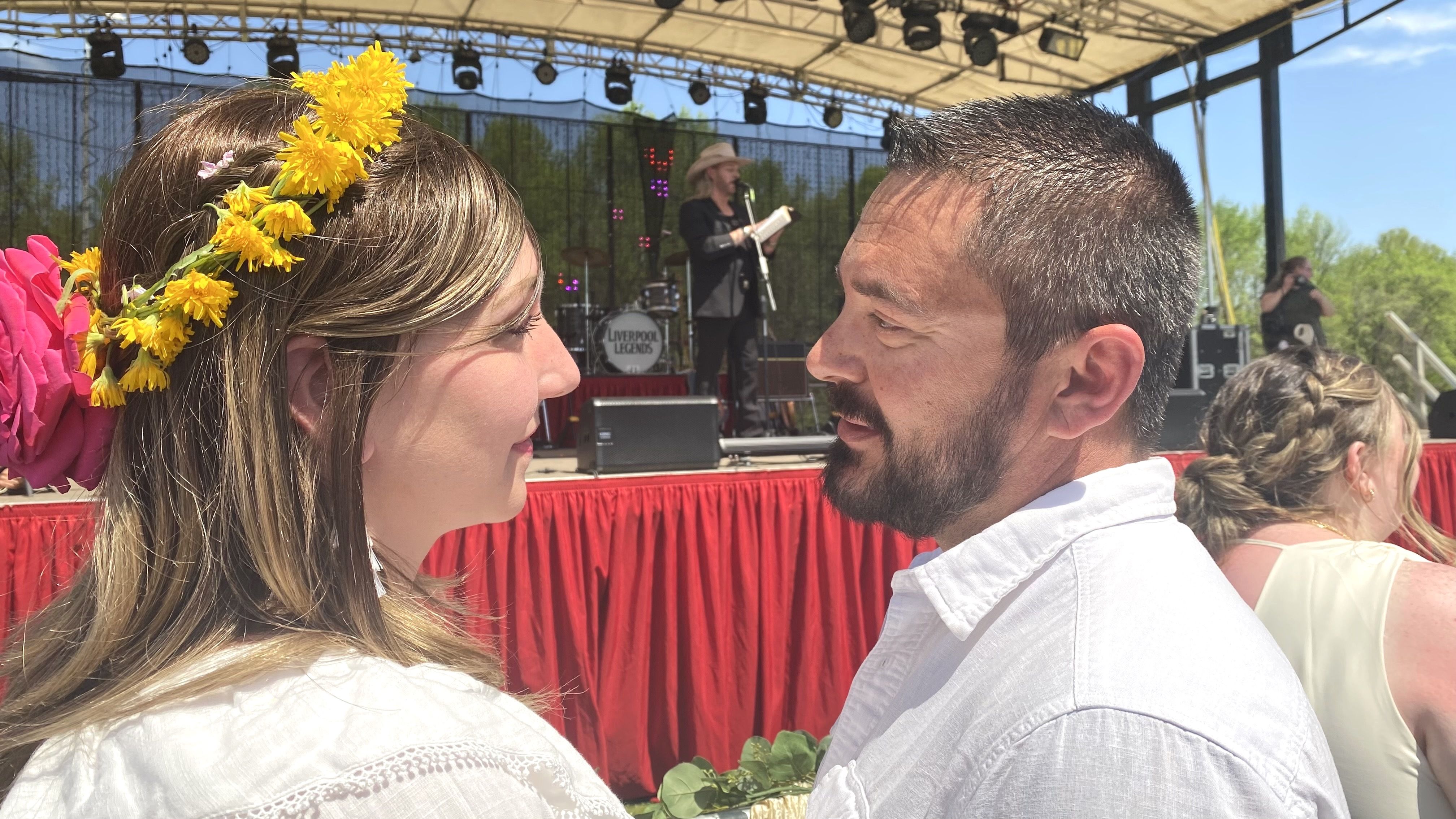 A couple stares into each others' eyes as they get married. 