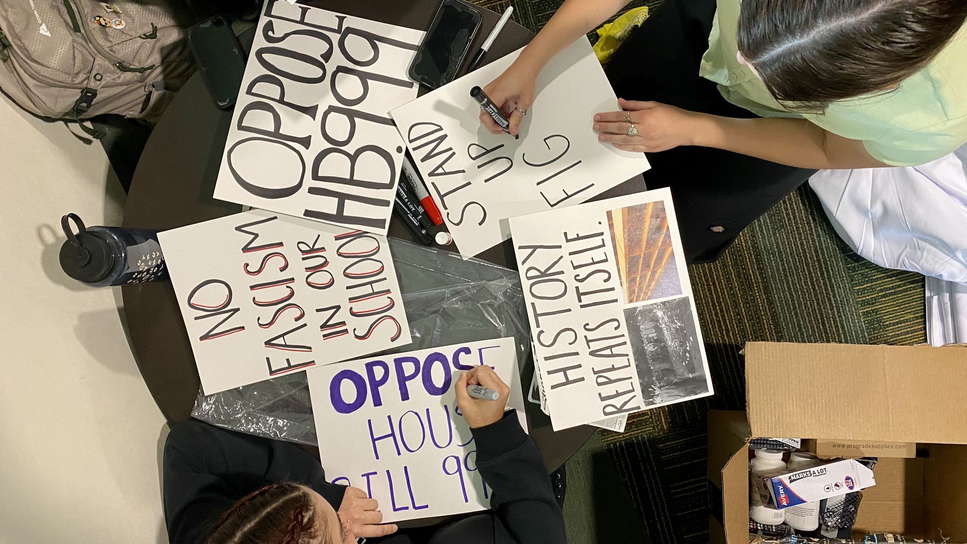 Students make signs opposing HB999.