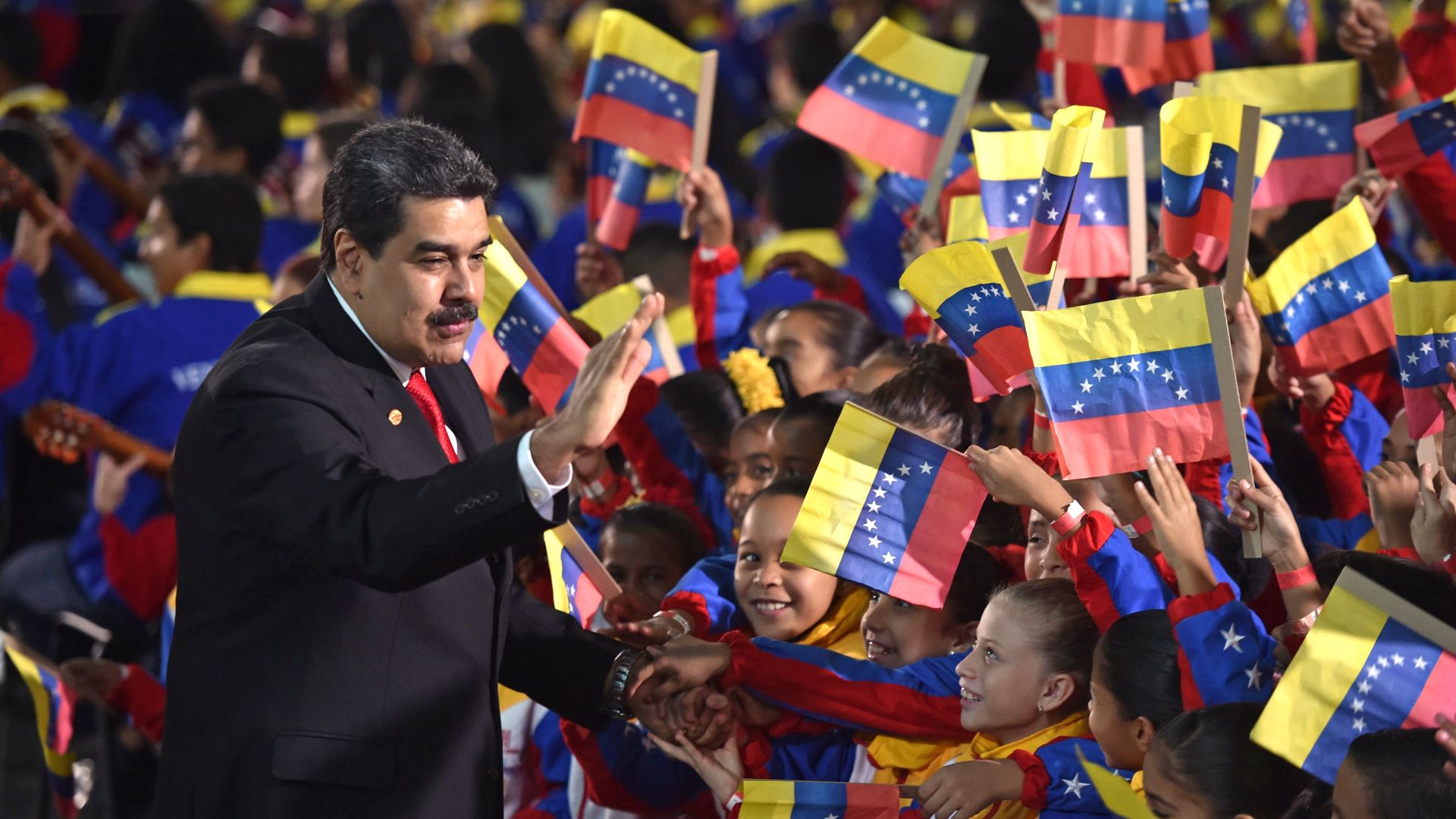 Venezuela's President Nicolas Maduro greets children upon arrival for the inauguration ceremony of his second mandate