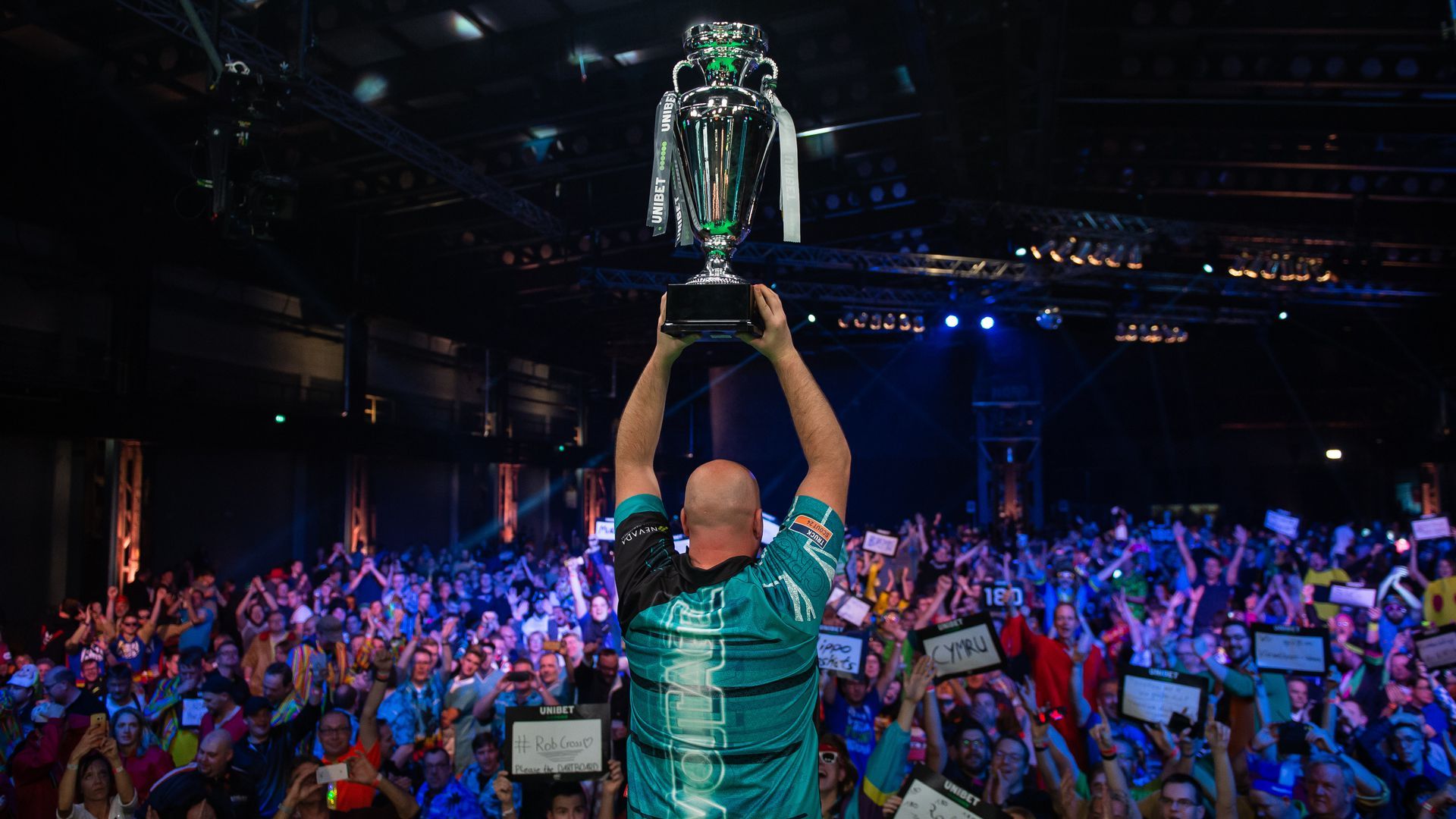 Rob Cross holding a trophy.