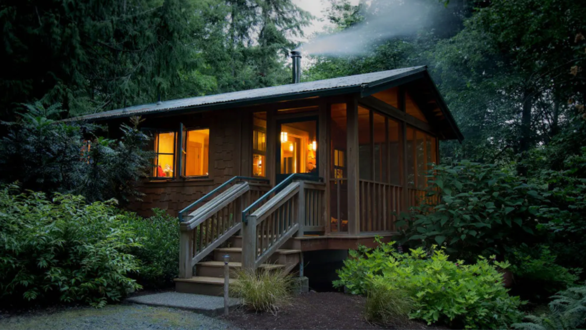 A little cabin is seen through mist in a forest in Washington state.