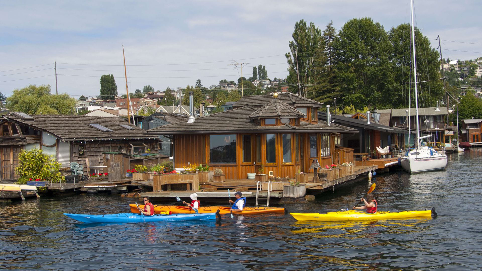 People in lifejackets kayak in Seattle's Lake Union. 