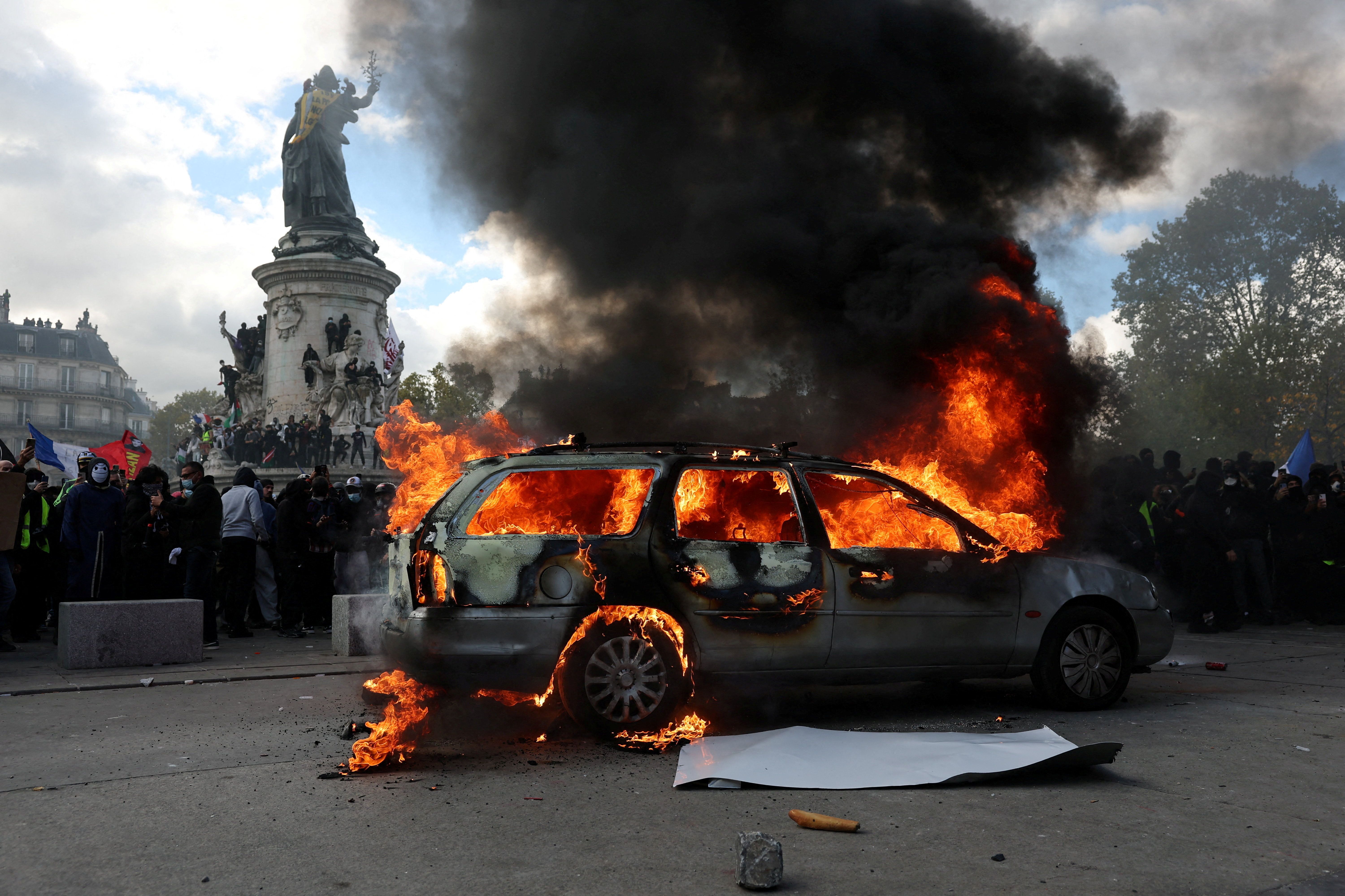 A car burns in the Place de la République in Paris yesterday. Photo: Stephanie Lecocq/Reuters