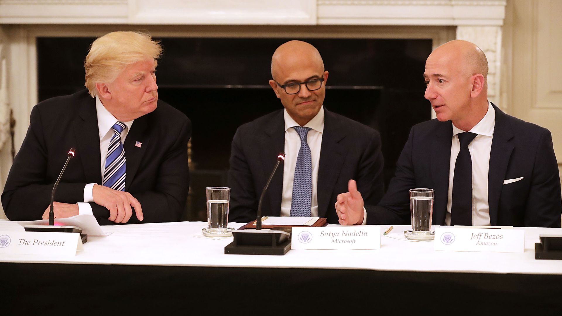 Trump sitting at table with tech leaders Jeff Bezos and Satya Nadella