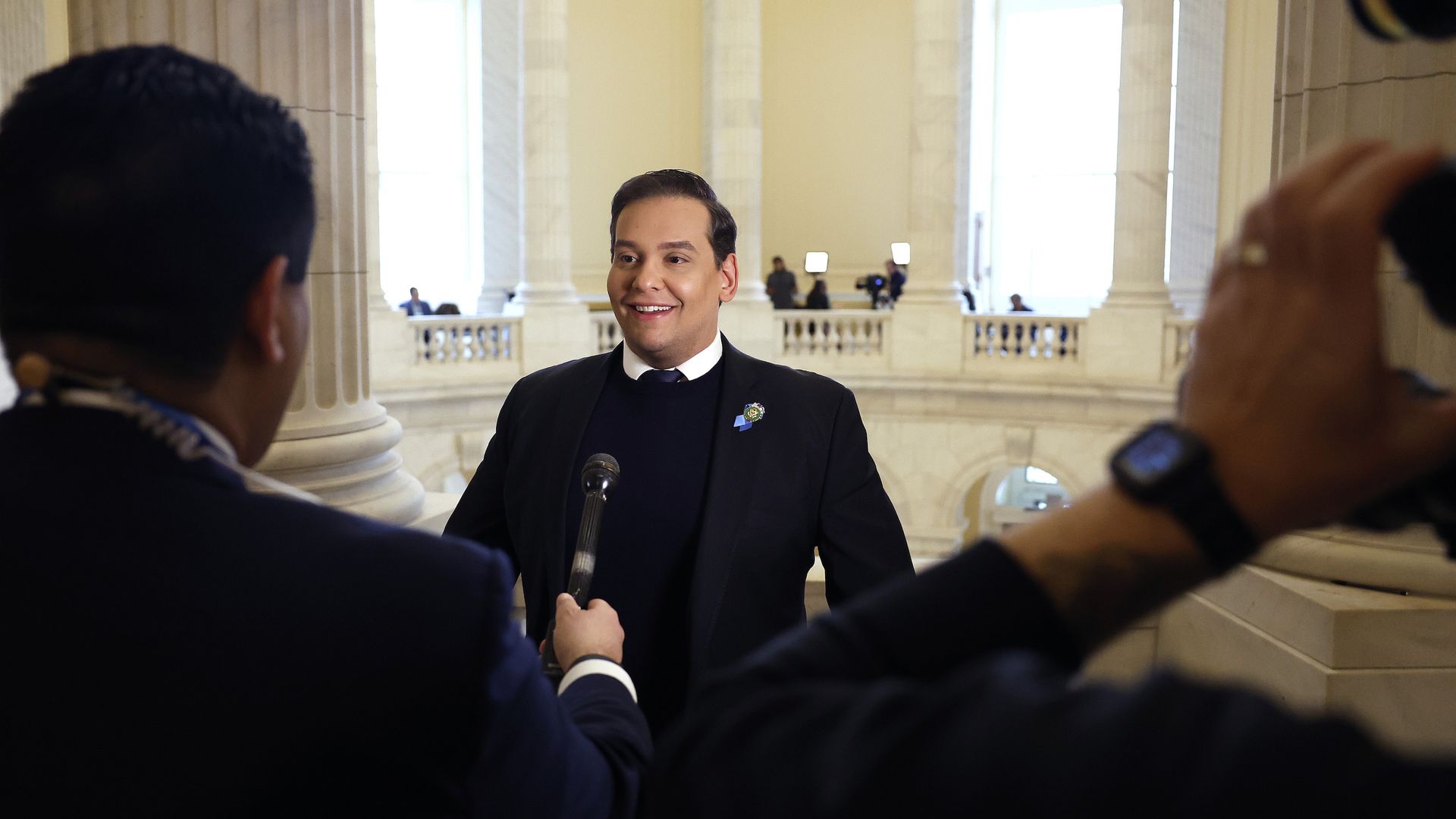 George Santos in front of reporters in the Capitol building