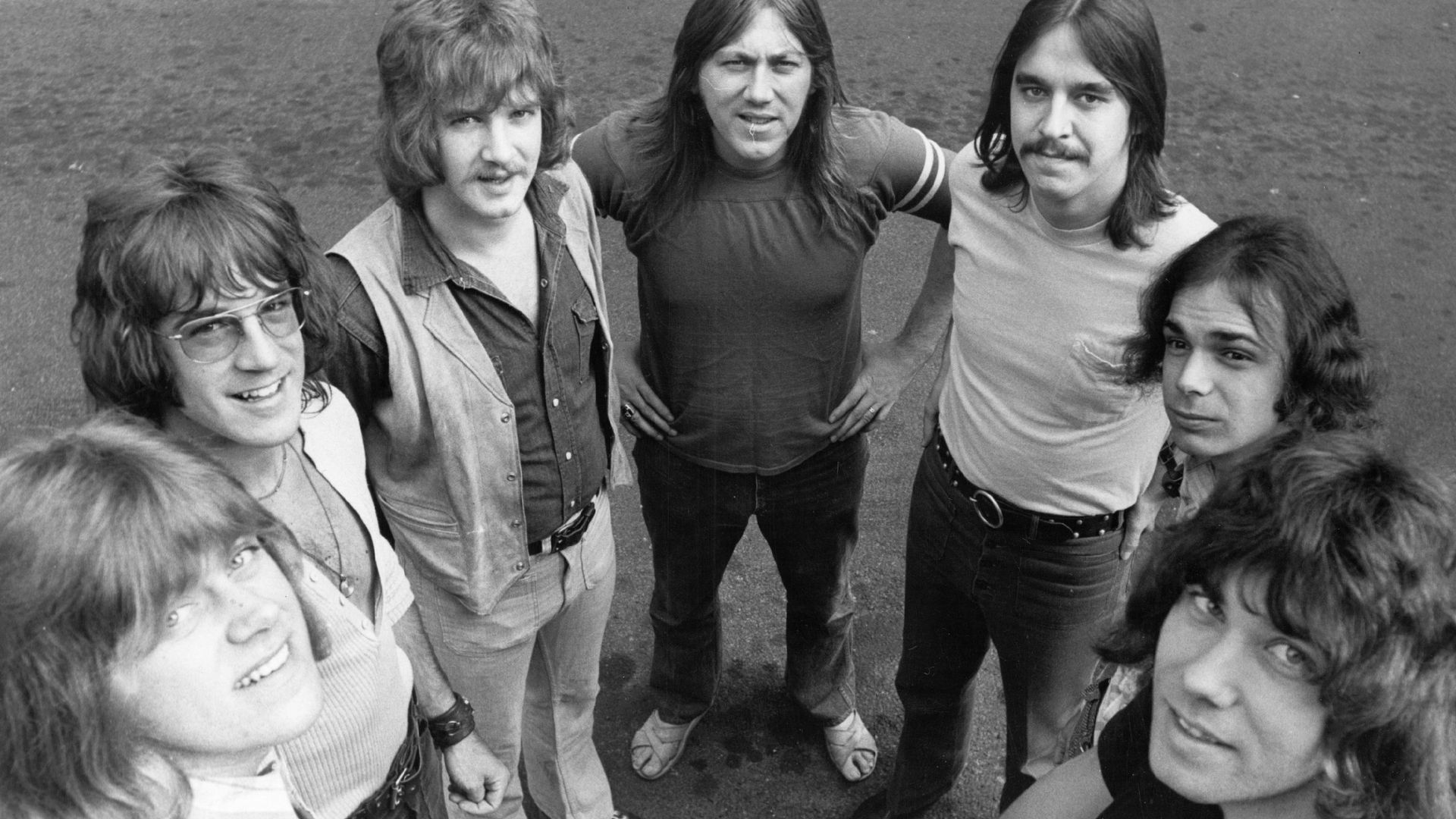 Photo of a rock band posing.