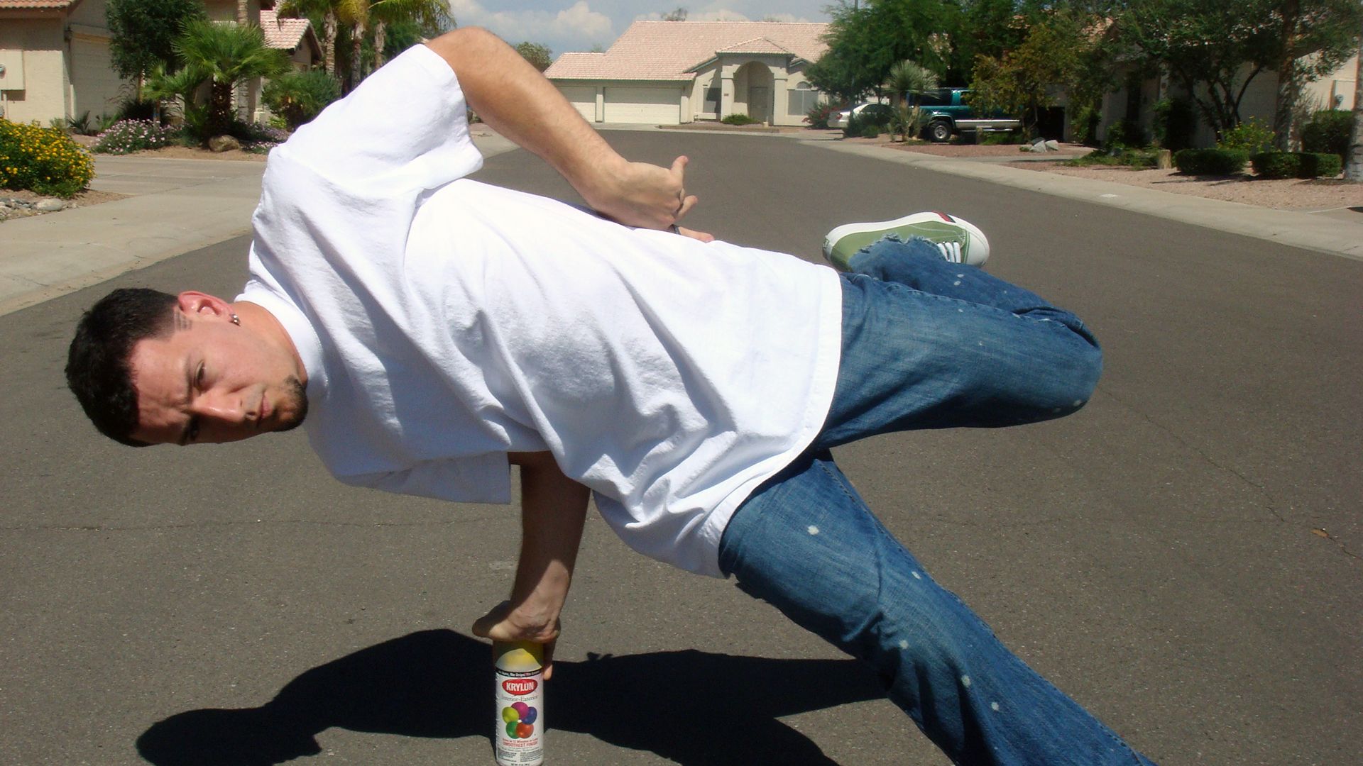 Legendary B-Boy YNOT balances himself on a can of spray paint.