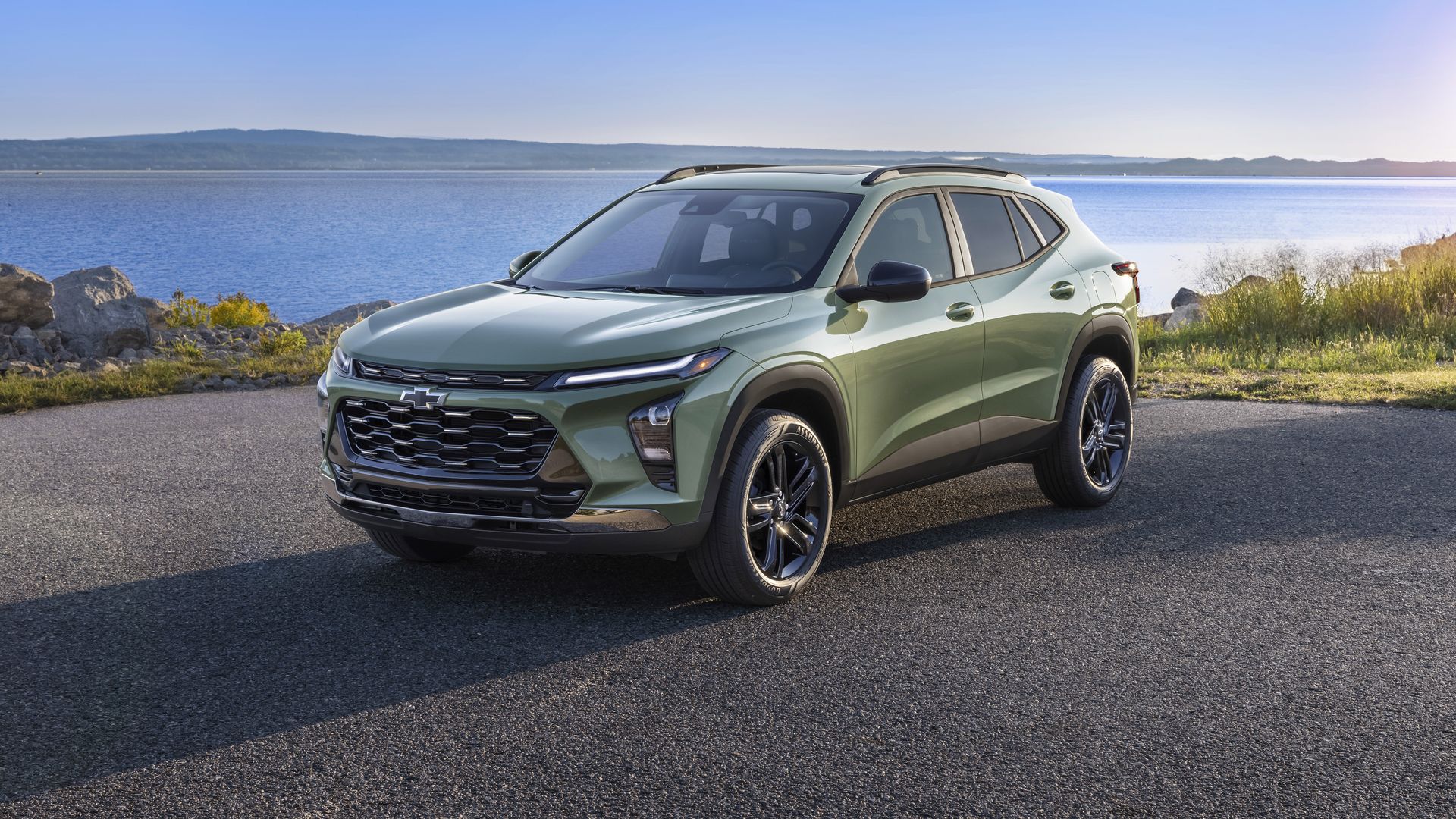 Image of a green Chevrolet Trax SUV parked in front of a lake