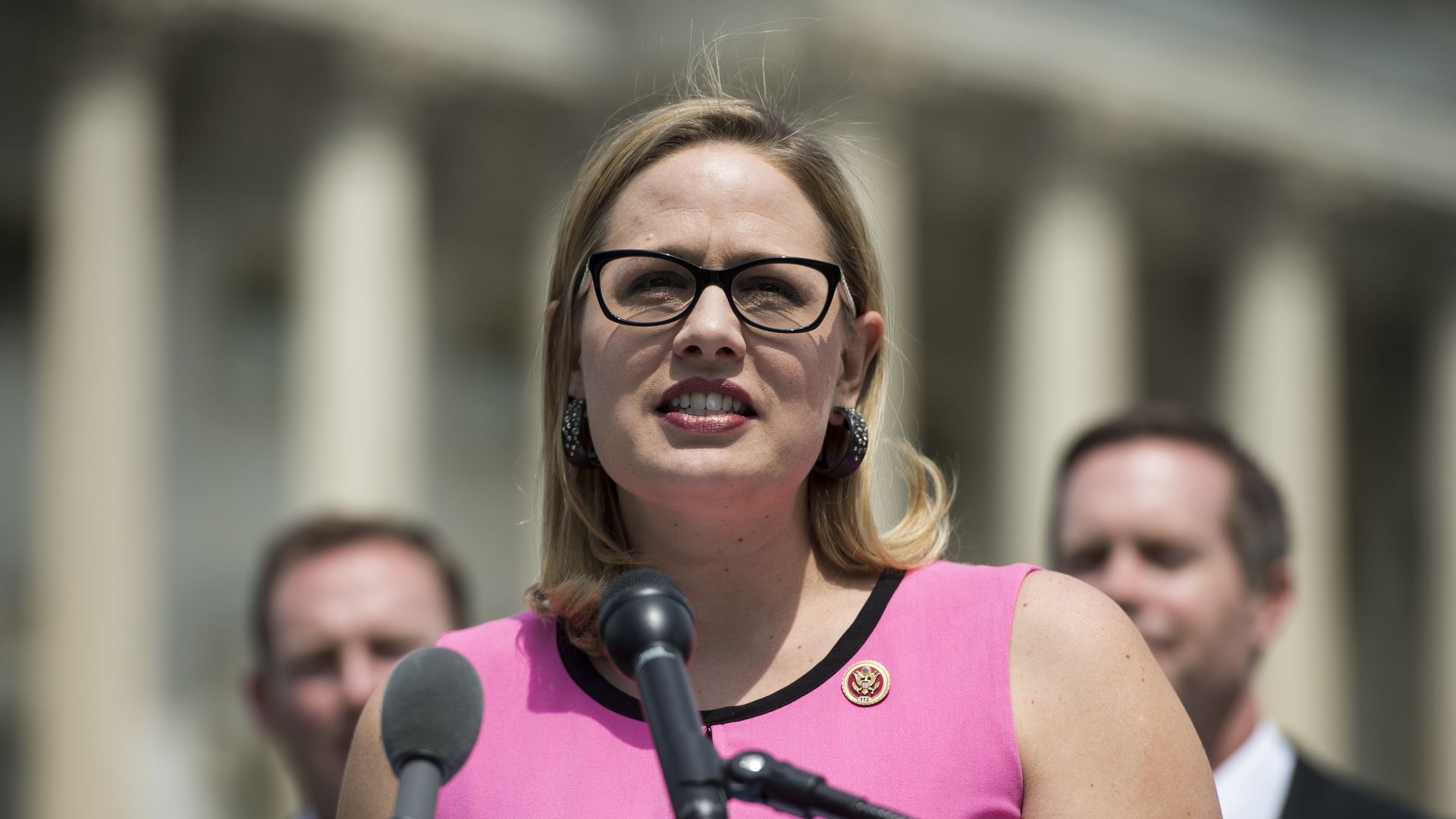 Kyrsten Sienma speaking at a news conference