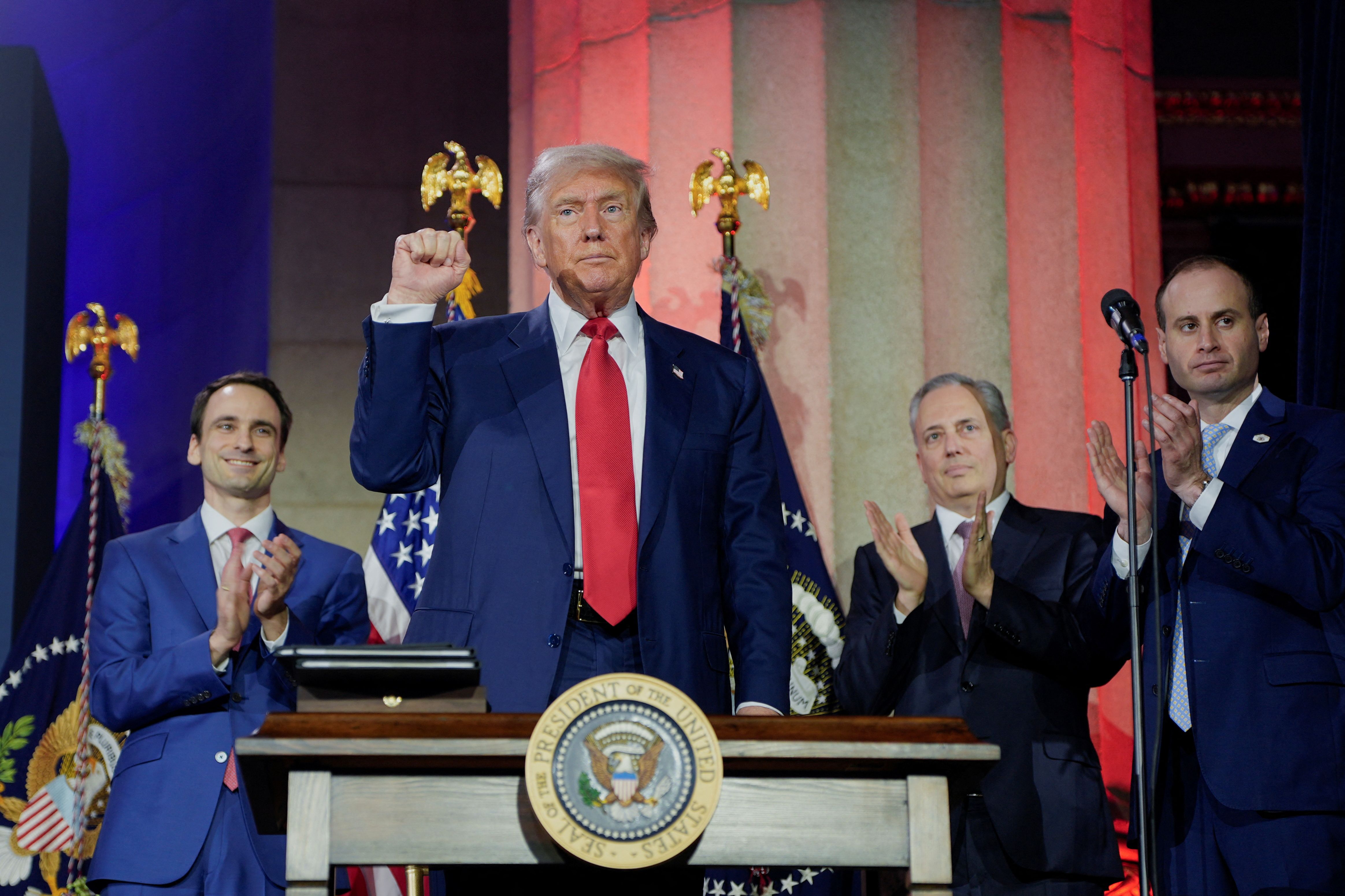 President Trump signs executive orders at an AI summit in D.C. yesterday.