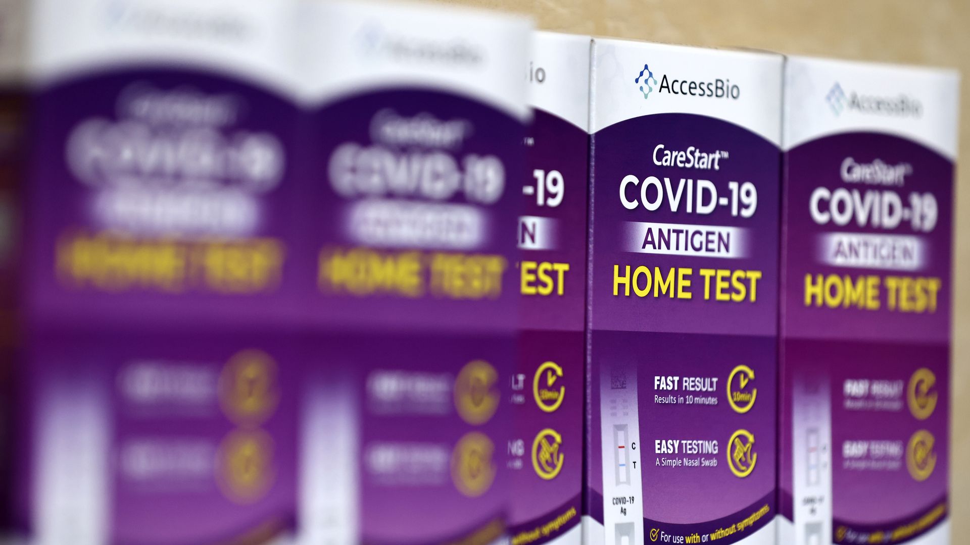  COVID-19 rapid at-home test kits rest on a table