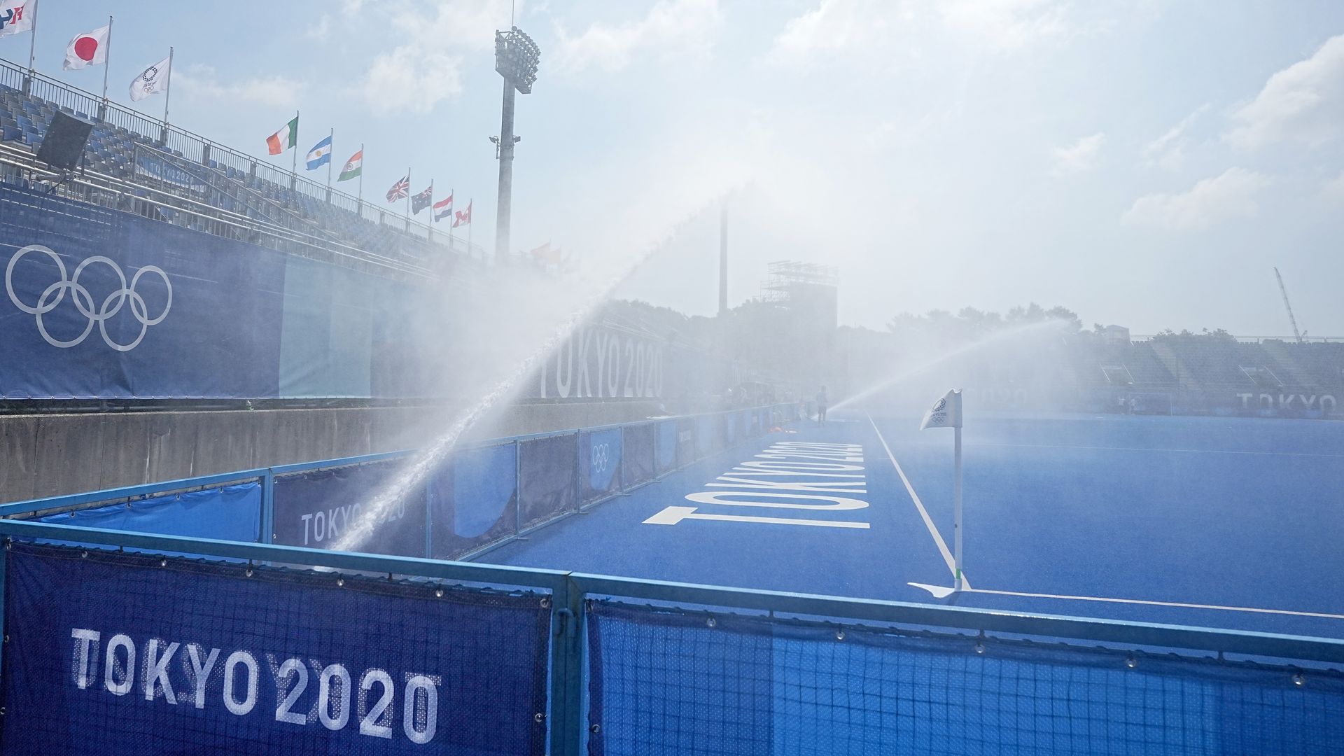 Sprinklers spraying a pitch with water on July 20.