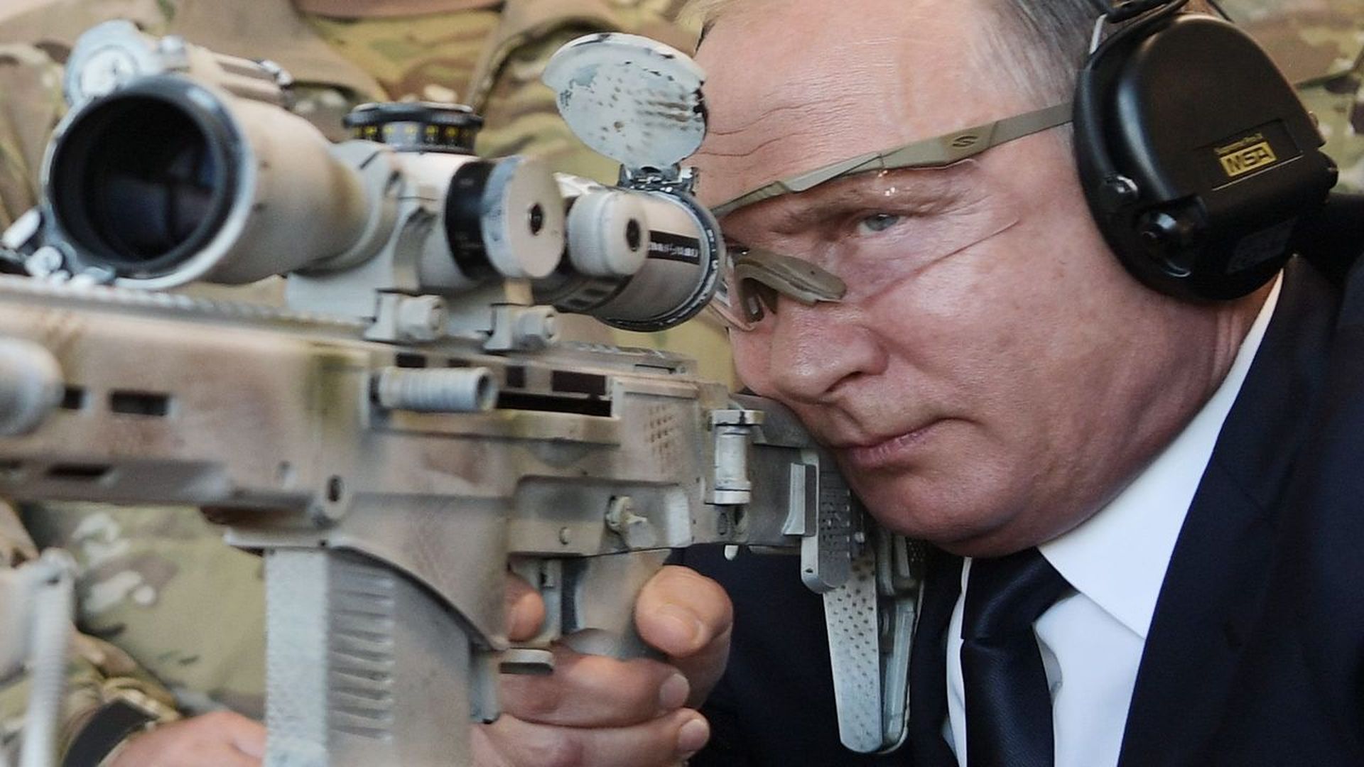 Vladimir Putin shoots an advanced Kalashnikov sniper rifle during a visit to the military-themed Patriot Park outside Moscow, in September. Photo: Alexey Nikolsky/AFP/Getty Images
