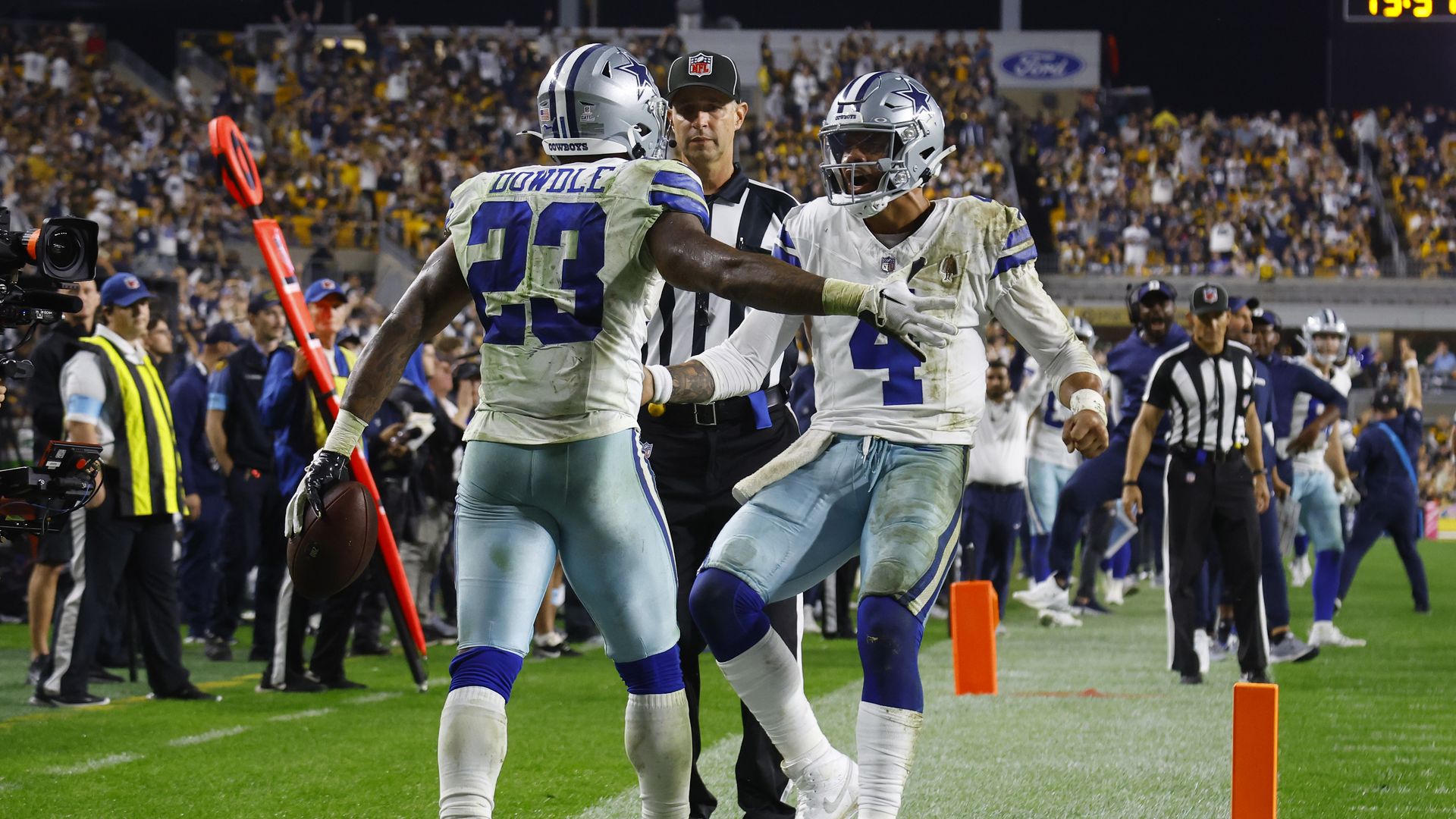 Two football players celebrate on the field