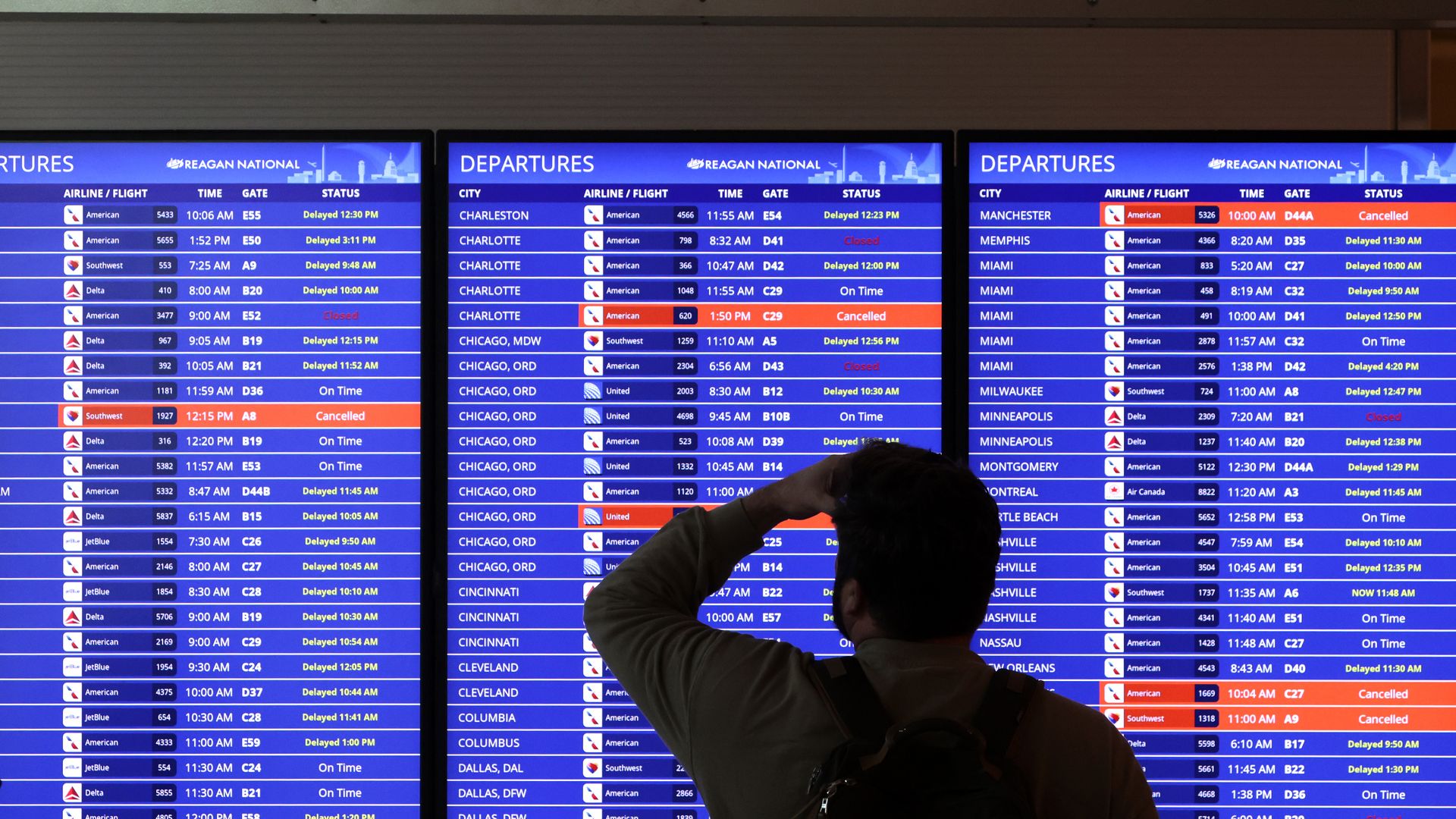 A traveler looks at a flight information board at Ronald Reagan Washington National Airport on January 11, 2023 in Arlington, Virginia. 